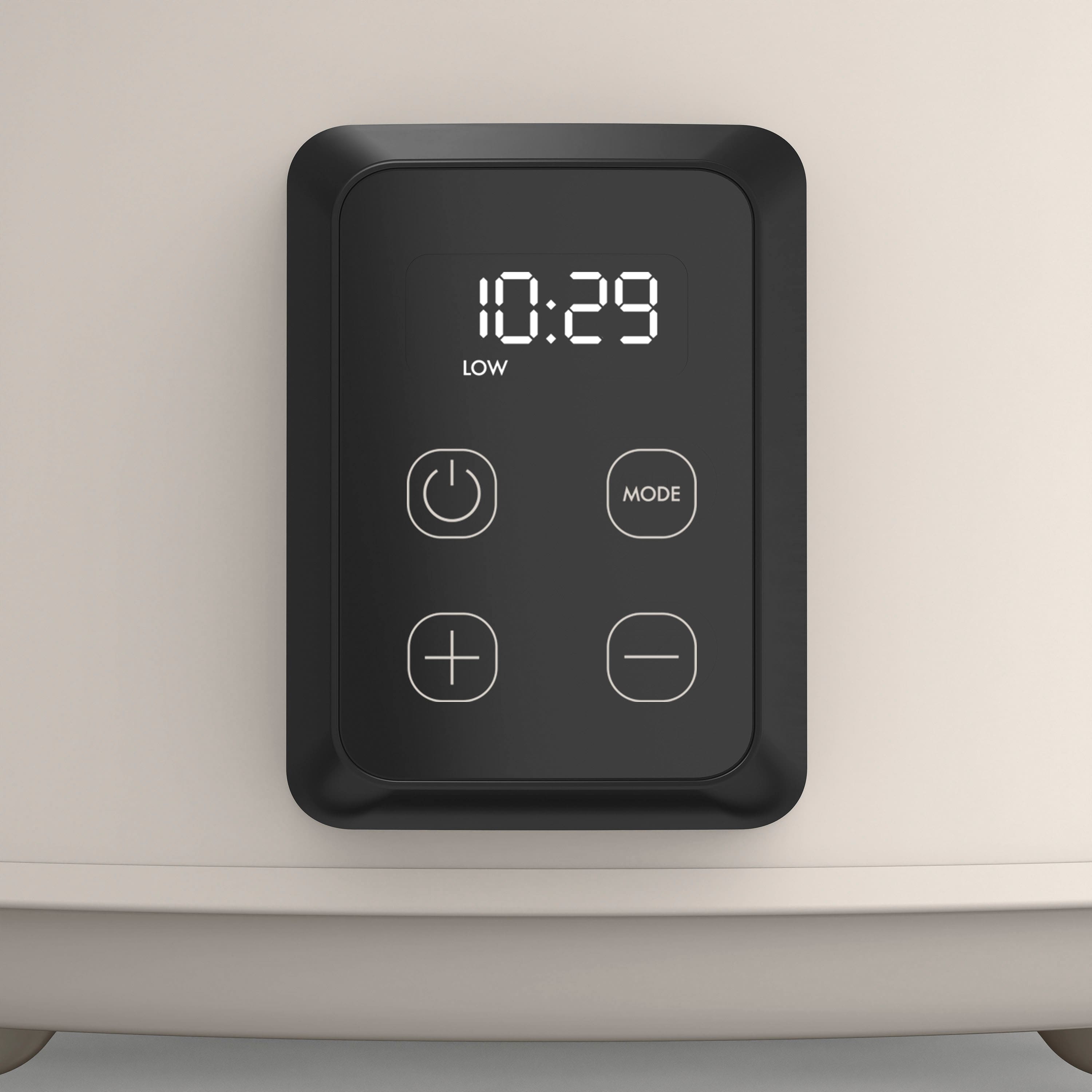 The image shows a digital clock with the time 10:29 displayed on it. The clock is attached to a device, likely a microwave or an oven, and has a low mode button. The clock is positioned on top of the device, making it easily visible and accessible for users.