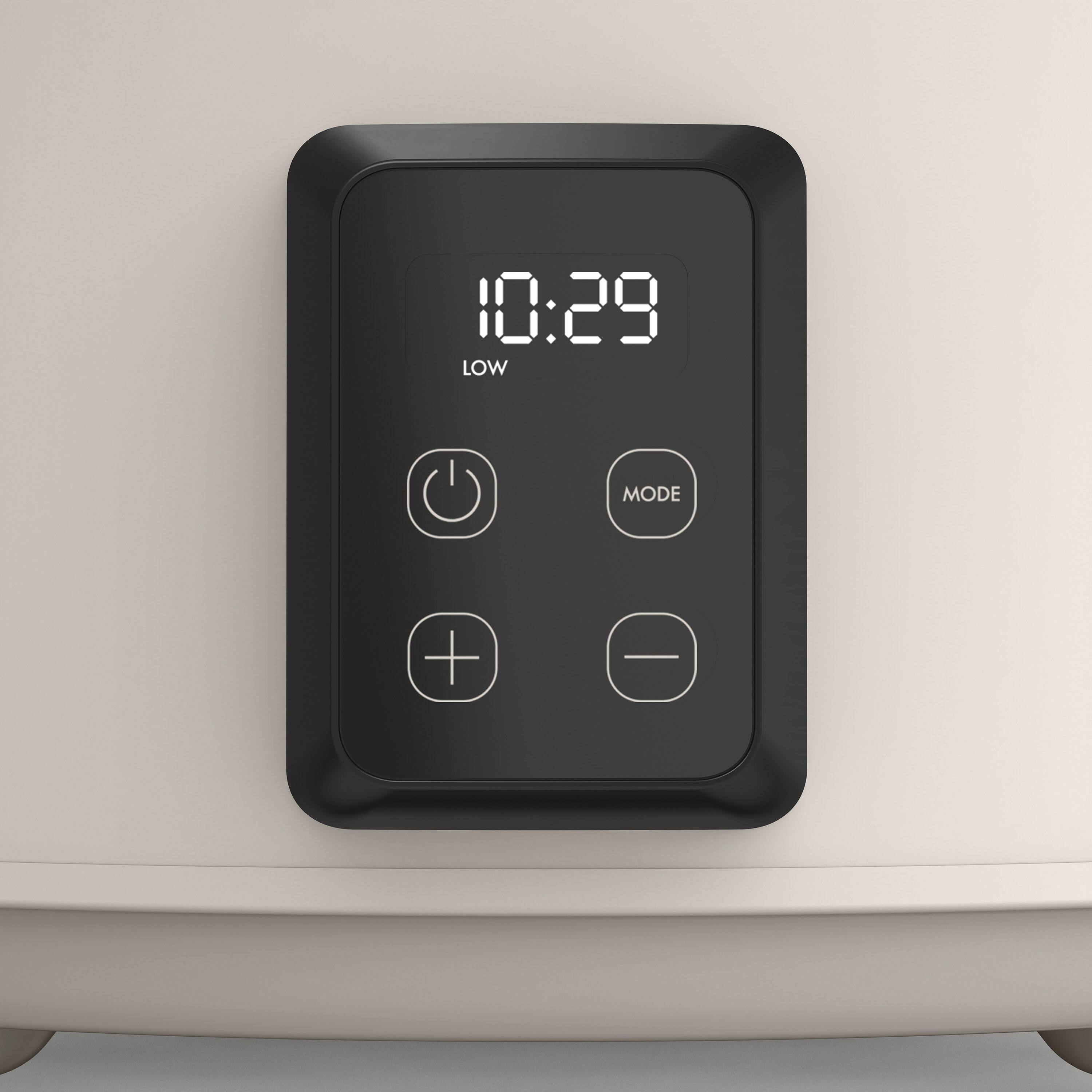 The image shows a digital clock with the time 10:29 displayed on it. The clock is attached to a device, likely a microwave or an oven, and has a low mode button. The clock is positioned on top of the device, making it easily visible and accessible for users.