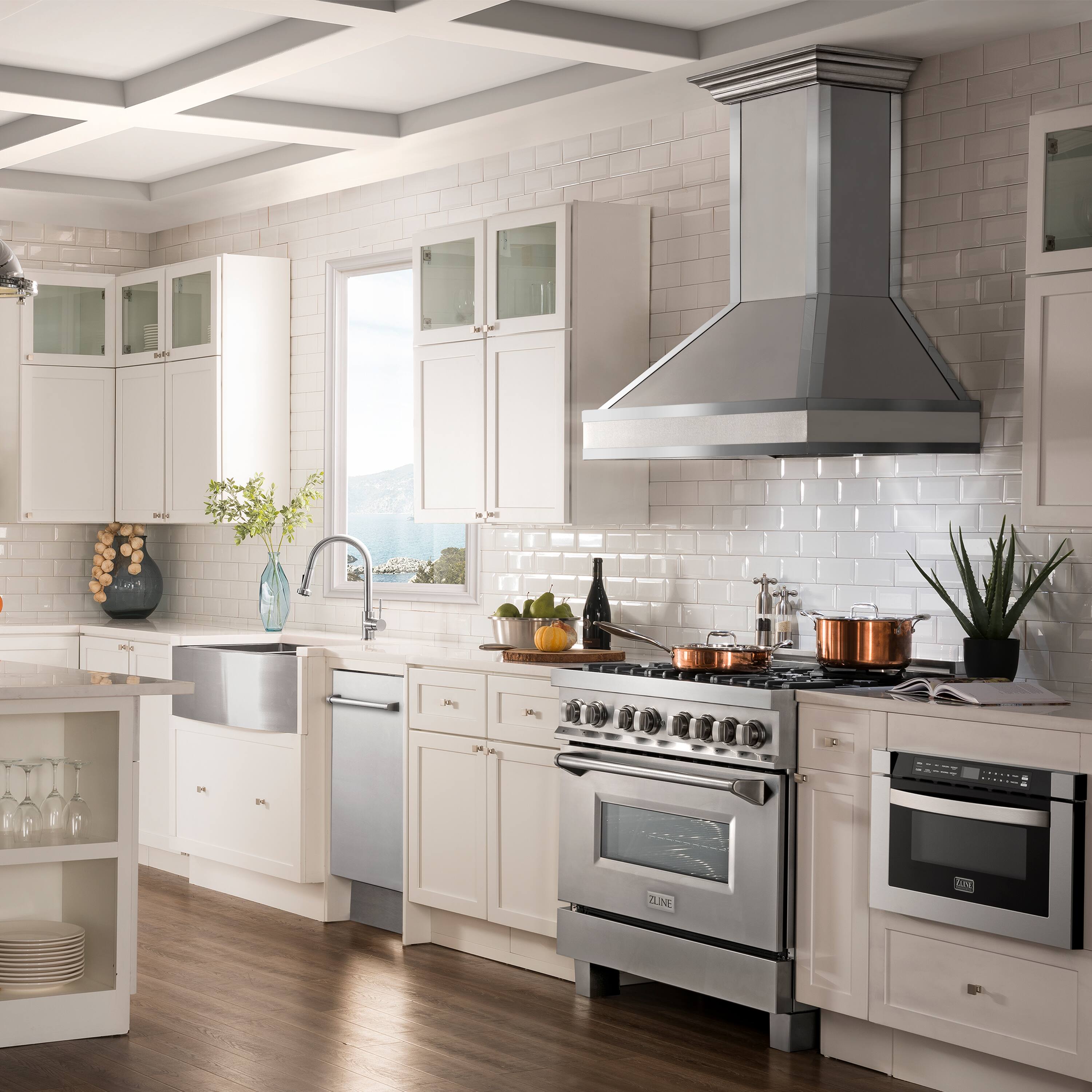 The image shows a large, clean kitchen with white cabinets and a stainless steel stove. The kitchen is equipped with a sink, an oven, and a microwave. There are also various items on the countertops, such as a bowl, a vase, and a potted plant. The kitchen appears to be well-maintained and organized, with a focus on cleanliness and functionality.