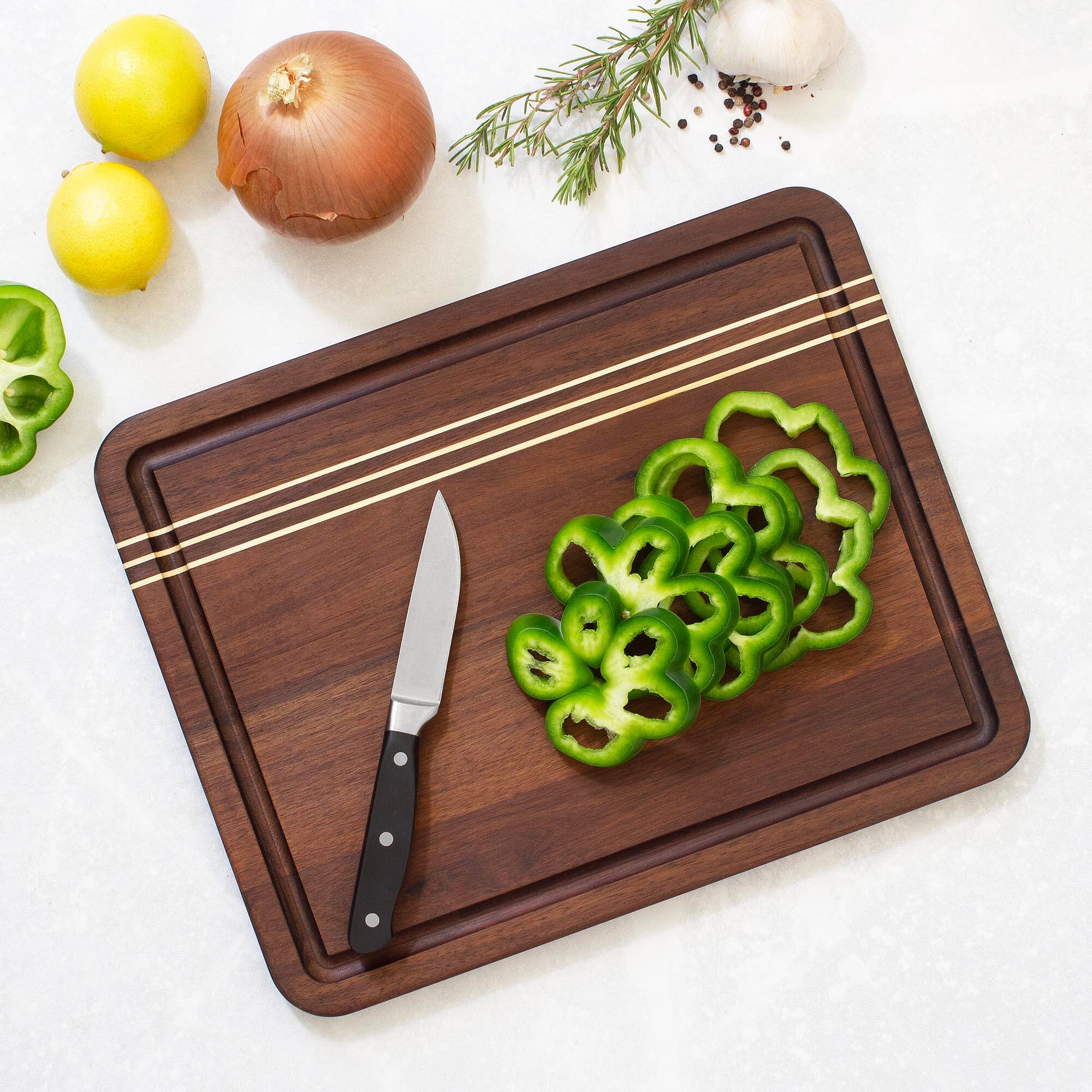 Angle. Rock & Branch - Acacia Wood Pinstripe Cutting Board, 14" x 11".
