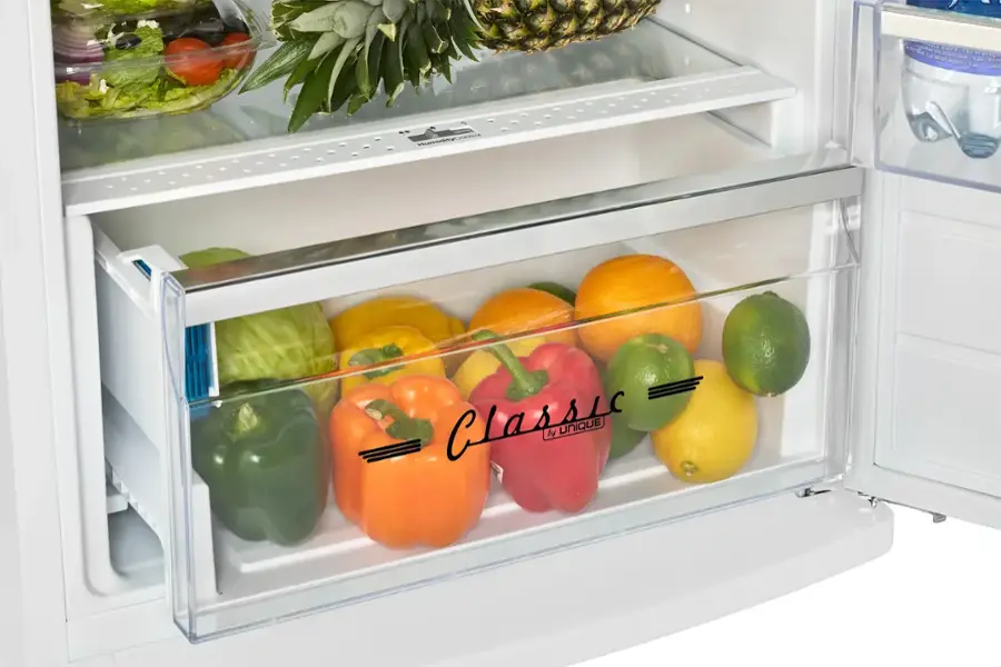 A Classic Tupperware container is filled with a variety of fruits and vegetables.