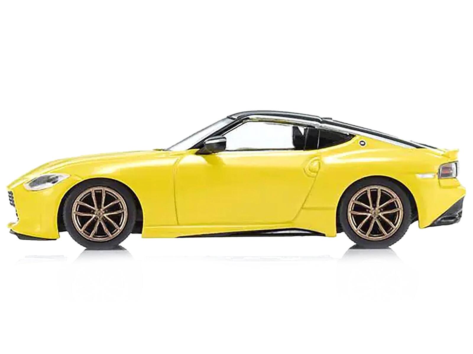 Left. Kyosho - Nissan Fairlady Z RHD (Right Hand Drive) Ikazuchi Yellow with Black Top with Mini Book No.13 1/64 Diecast Model Car - Yellow with Black.