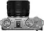 The text on the image reads: "15-45 RIA C S N V NN FILM STD A C FS1 FS2 FS3 DRIVE FUJIFILM S A a M P  AUTO C2 ON OFF Vlog C3 FILTER C4 Q AEL/AFL." This is a description of a camera, likely a Fujifilm camera, with various features and settings.