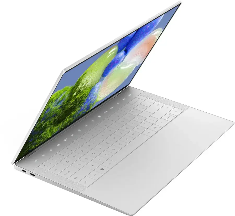 The image shows a laptop with a large screen, which is open and displaying a picture of a flower. The laptop is white and has a keyboard, with the screen taking up a significant portion of the device. The image also includes a few words, but they do not seem to be related to the main focus of the laptop and its screen.