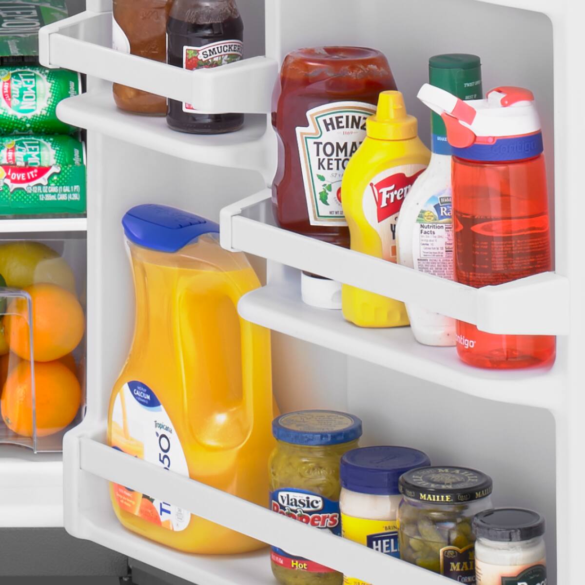 Sure, here is the corrected and grouped text from the image:

**Top Shelf:**
- SMUCKER'S
- HEINZ TOMATO KETCHUP
- FREEmayo
- CORNICO

**Middle Shelf:**
- LEMON
- LOVE IT! (12-355mL CANS)
- Nutrition Facts
- CALCIUM 50%

**Bottom Shelf:**
- Tropicana
- Classic Deubers
- HEL
- MA
- Hot
- MAILLE
- MAILLE