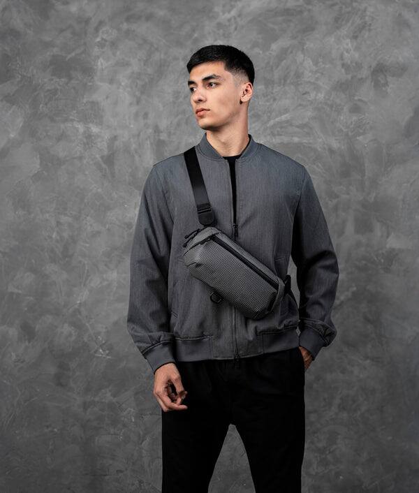 Angle. ALPAKA - Lightweight Crossbody Sling Bag for Travel, Phone, Wallet & Passport, Momentum Sling, Weather-Resistant - Axodyne hybrid Grey.