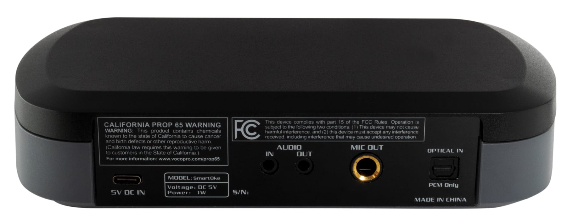 This device complies with part 15 of the FCC Rules. Operation is subject to the two conditions: (1) this device may cause interference, and (2) this device must accept any interference, including interference that may cause undesired operation and birth defects or other reproductive harm. California law requires this warning to be given to customers in California. The device has an audio/mic out and an optical in. The model is SmartOke, and it has a voltage of DC SV and a power of 1W. The serial number is PCM Only, and the device is made in China.