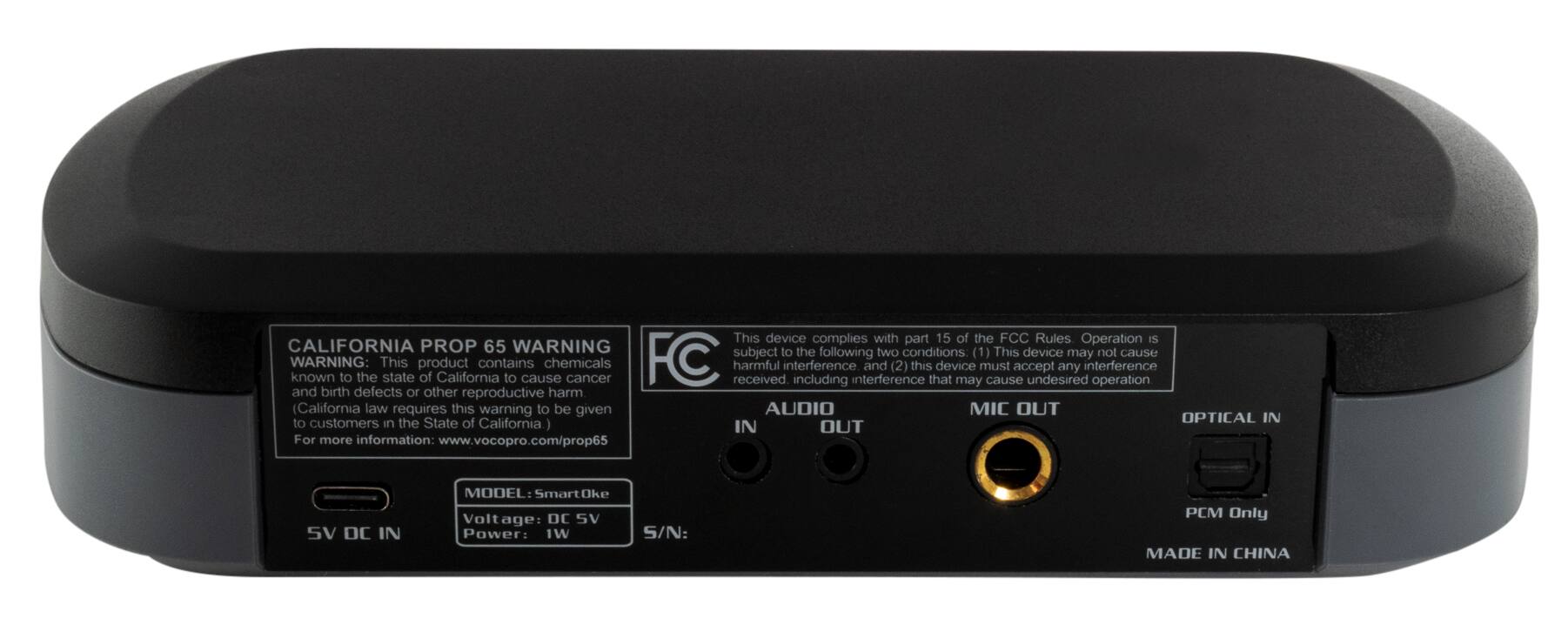 This device complies with part 15 of the FCC Rules. Operation is subject to the two conditions: (1) this device may cause interference, and (2) this device must accept any interference, including interference that may cause undesired operation and birth defects or other reproductive harm. California law requires this warning to be given to customers in California. The device has an audio/mic out and an optical in. The model is SmartOke, and it has a voltage of DC SV and a power of 1W. The serial number is PCM Only, and the device is made in China.