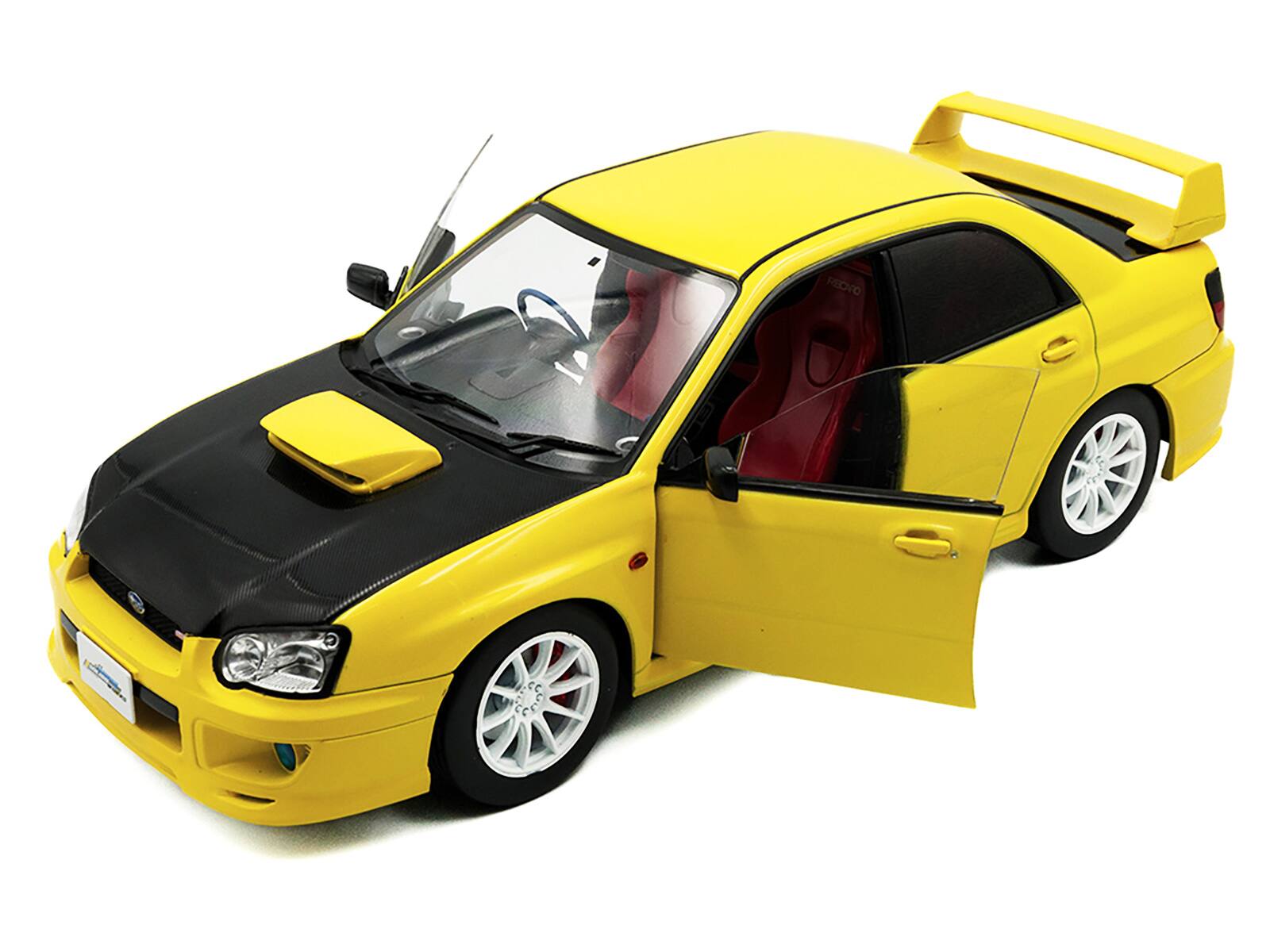 Angle. Solido - 2003 Subaru Impreza WRX STI RHD (Right Hand Drive) Yellow with Carbon Hood 1/18 Diecast Model Car by Solido - Yellow.