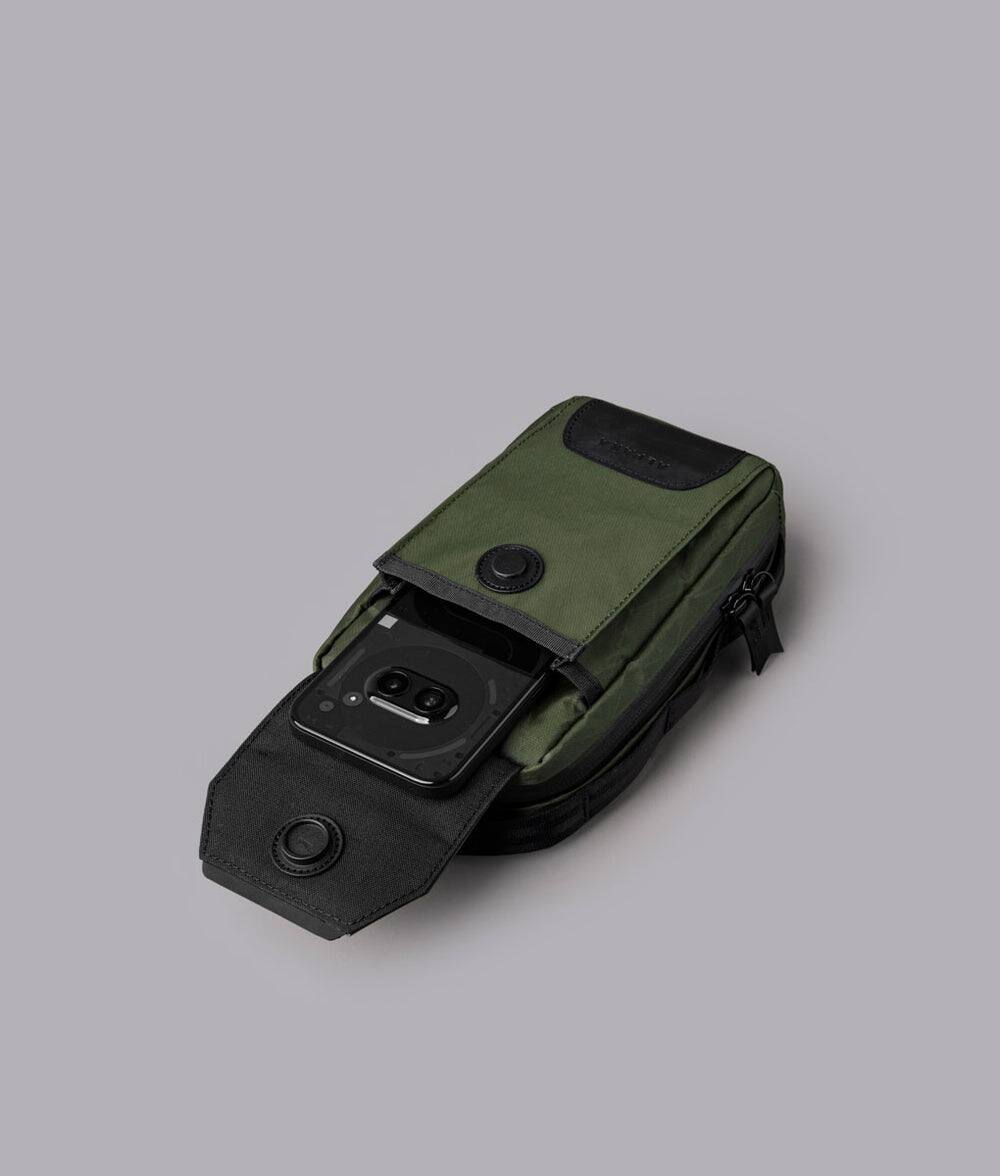 Alt View 1. ALPAKA - Modular Sling V2 MIini Sling Bag for Phone, Magnetic Quick Access, EDC Crossbody Bag with Adjustable Strap - Dark Green X-Pac VX21.