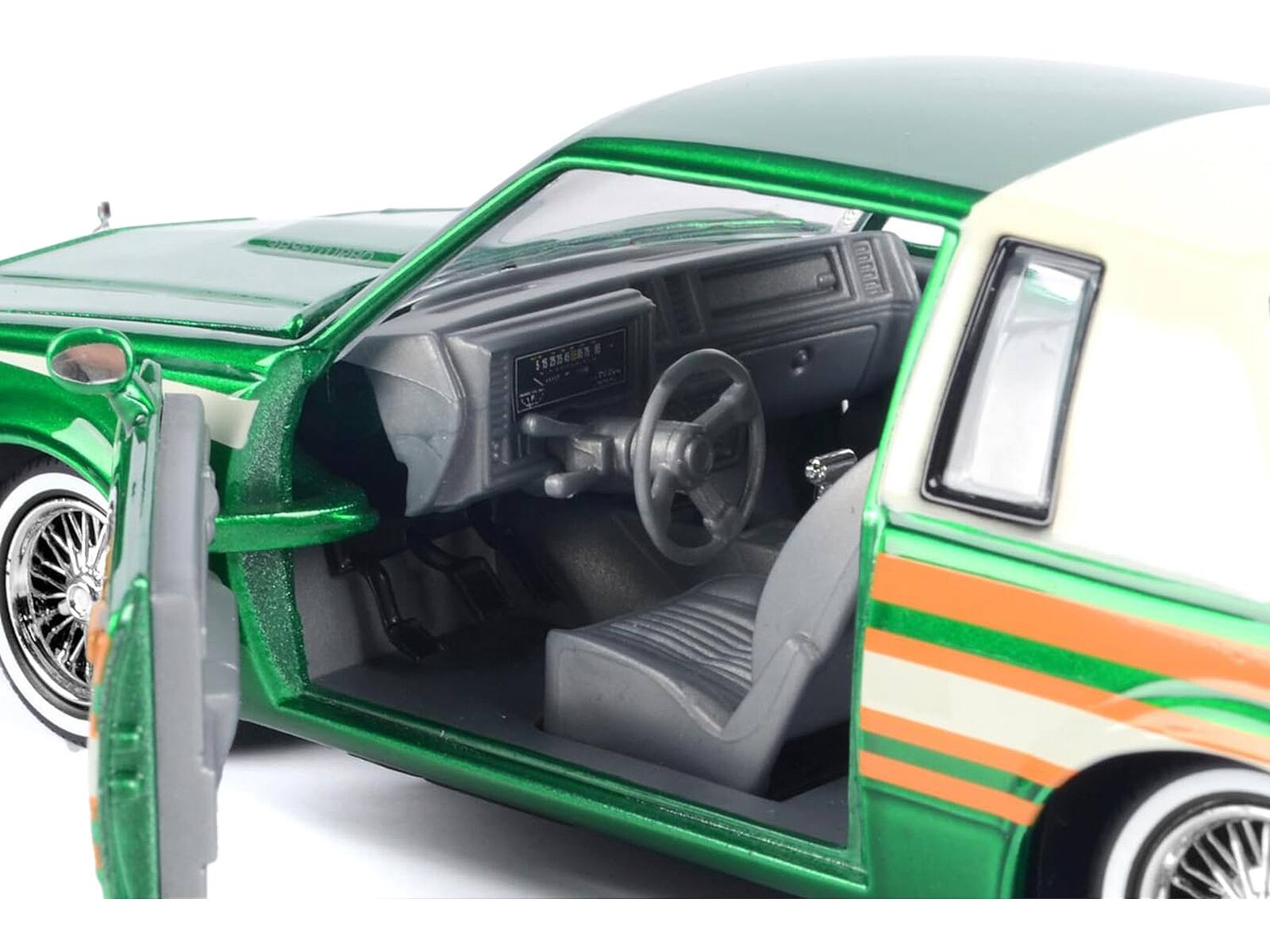 Alt View 1. Motormax - 1987 Buick Regal 3.8 SFI Turbo Green Metallic and Cream with Graphics "Get Low" Series 1/24 - Green Metallic And Cream.
