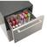 The image shows a silver container with a drawer that is filled with various cans of Coca-Cola. The cans are arranged in different positions, with some standing upright and others lying horizontally. The container is designed to hold and organize these cans, making it a convenient storage solution for the beverages.
