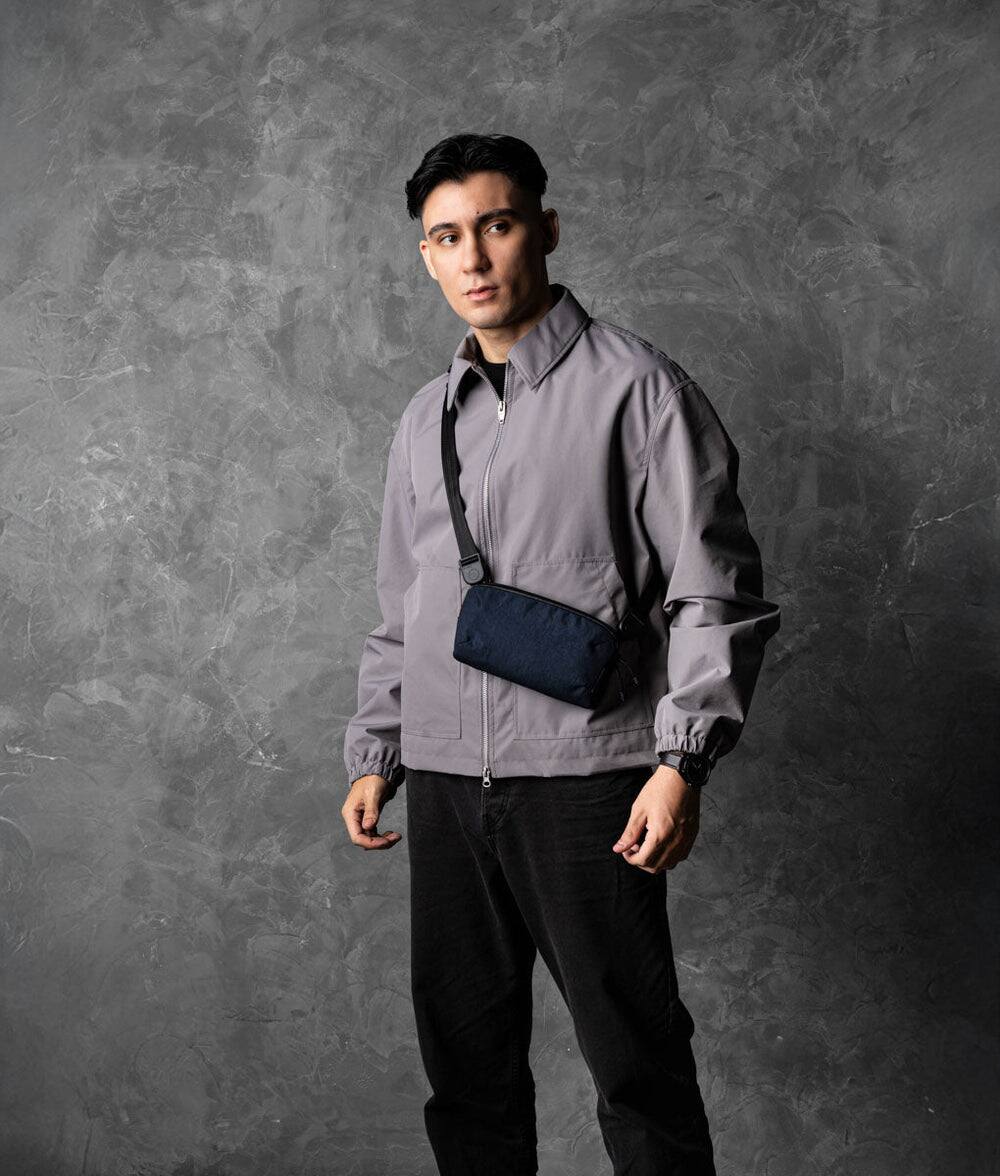 Angle. ALPAKA - Flight Pouch Pro 0.7L Men's Carry-All & Organizer Clutches;Crossbody Bag for Men with RFID Blocking, Passport Holder - Moonlight Blue | Axoflux 400D Ripstop Nylon.