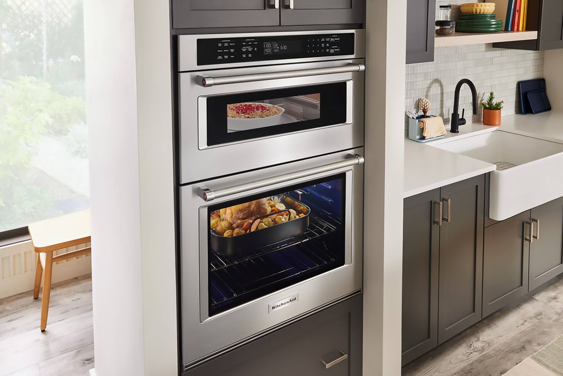 The text on the image reads "a m 10E 6:30 N0 S KitchenAid." This text is likely a part of the oven's display or timer settings. It could be indicating the time and temperature for a specific cooking task, such as baking or roasting a dish. The oven is a stainless steel model, which is a popular choice for modern kitchens due to its sleek appearance and durability.