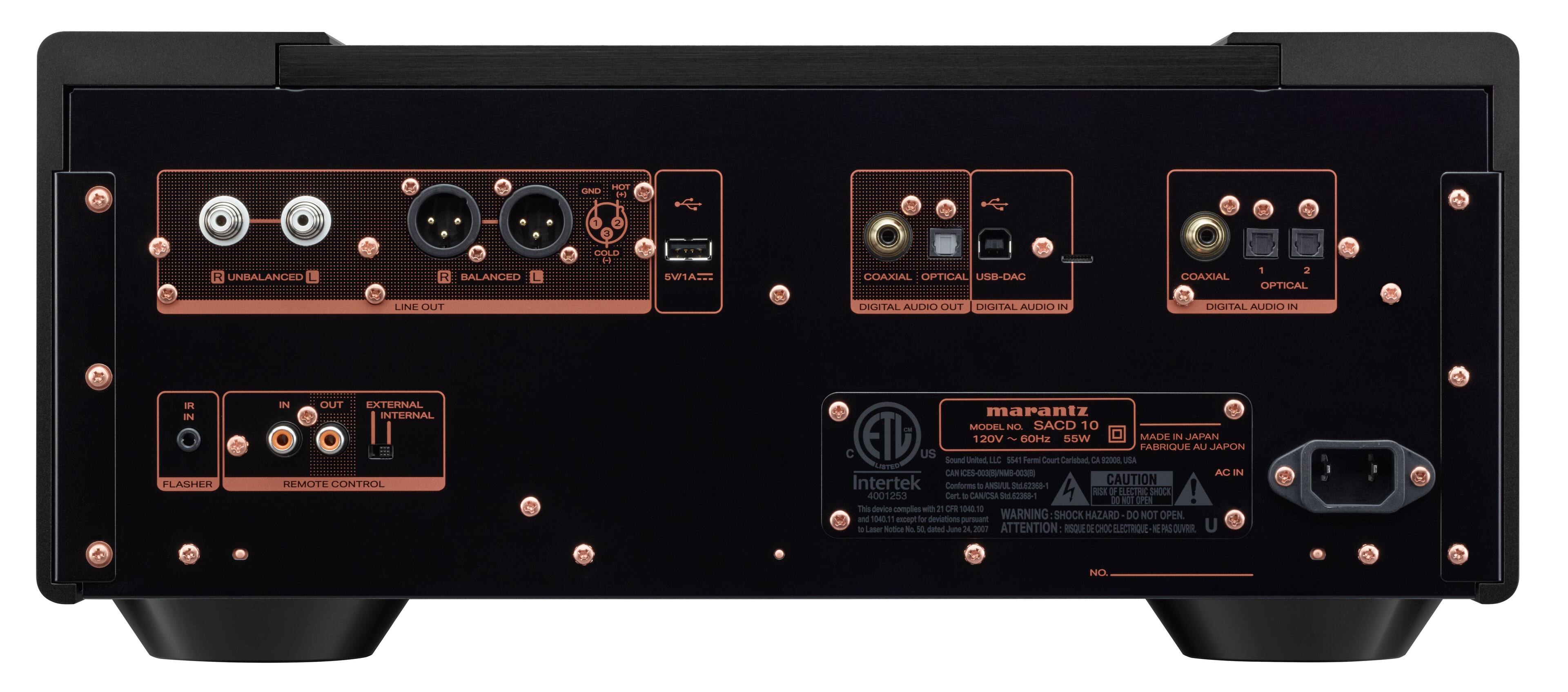 The image features a black electronic device, likely a stereo or sound system, with a variety of ports and connections. The device has a total of 12 ports, including coaxial, optical, USB-DAC, digital audio in, digital audio out, and line out. It also has a remote control and a flasher. The device is made in Japan and complies with safety regulations. The image is cautioning against opening the device, as it may pose a shock hazard.