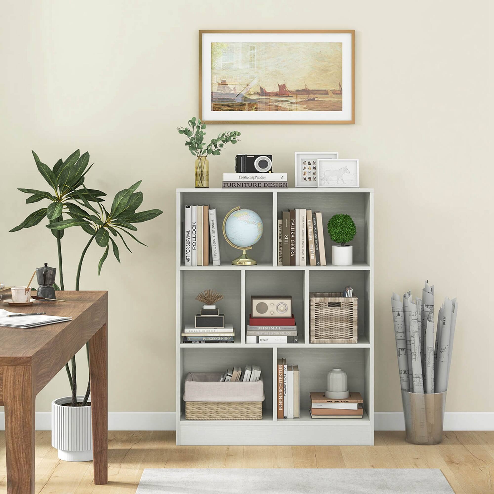 The image features a room with a bookshelf filled with books, a table, and a potted plant. The bookshelf is located in the corner of the room, and it is filled with various books. There is also a vase on the bookshelf, adding to the room's decor. The table is situated near the bookshelf, and the potted plant is placed on the floor, providing a touch of greenery to the space. The room appears to be a cozy and inviting living area, perfect for reading or relaxing.