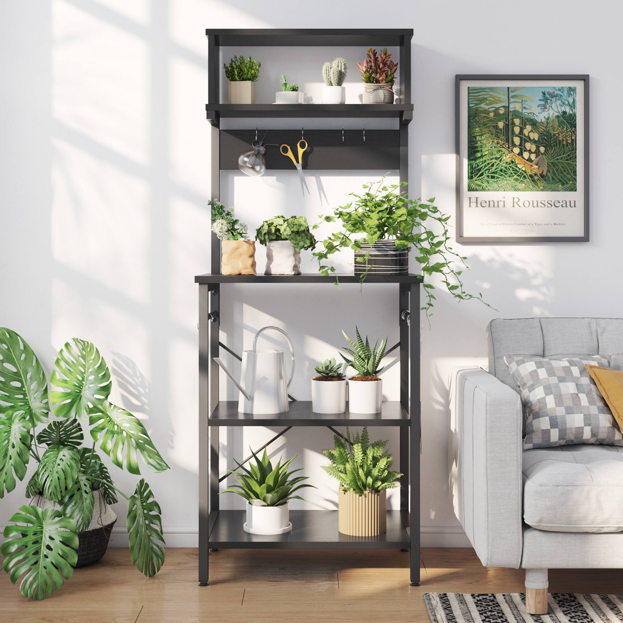 The image features a black shelf with several potted plants on it. There are a total of 12 potted plants, each with different sizes and shapes. The shelf is placed next to a couch, and a picture is hanging on the wall above the shelf. The plants are arranged in various positions on the shelf, creating a visually appealing display. The combination of the plants and the couch creates a cozy and inviting atmosphere in the room.