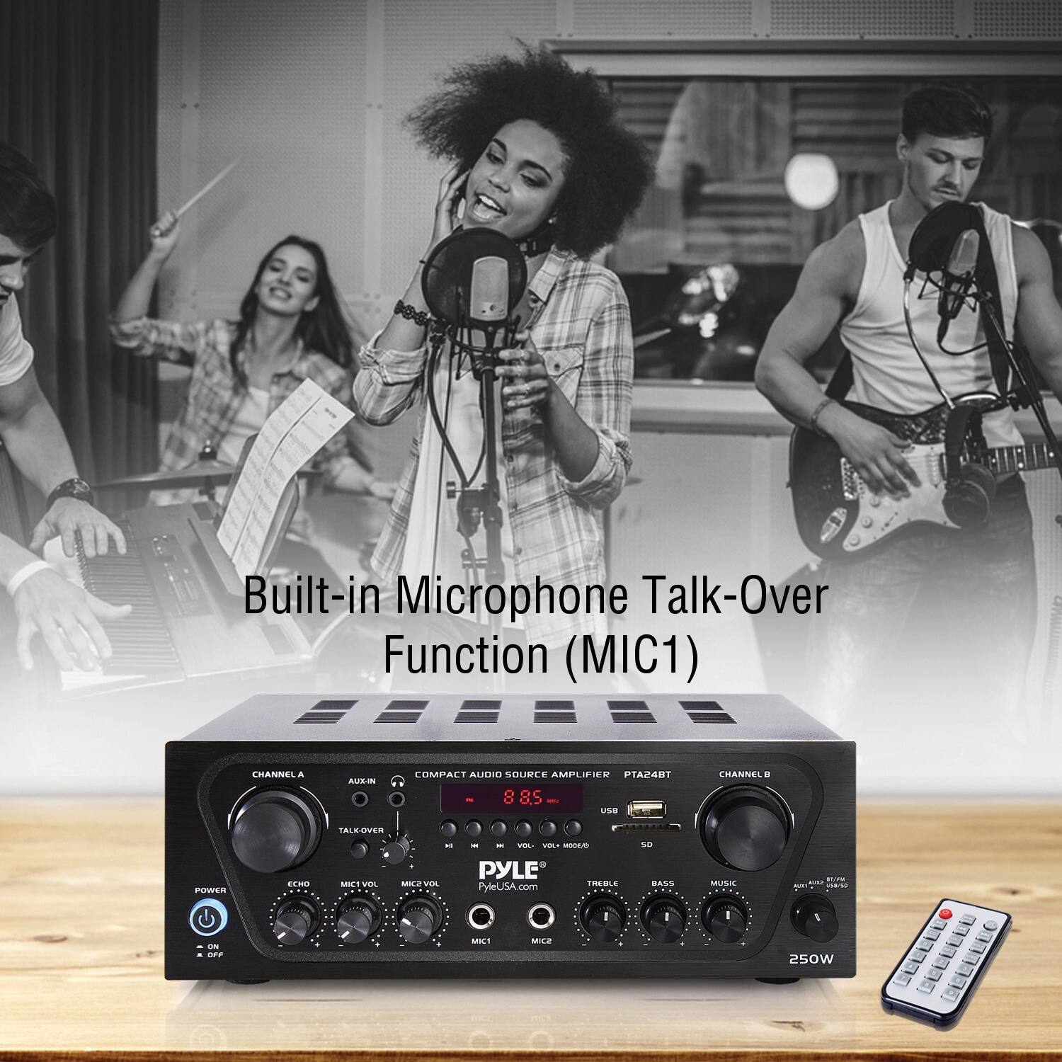 The image features a group of people singing into microphones, with a focus on a woman singing into a microphone. The scene also includes a mixer with a built-in microphone talk-over function (MIC1) and a compact audio source amplifier. The mixer is placed on a table, and a remote control is located nearby. The image showcases the audio equipment and the people using it to create a musical performance.