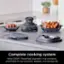Ninja CRISPI Complete Cooking System Ninja CRISPI PowerPod, big-batch 4-qt container, small-batch 6-cup container, adapter, and storage lids.