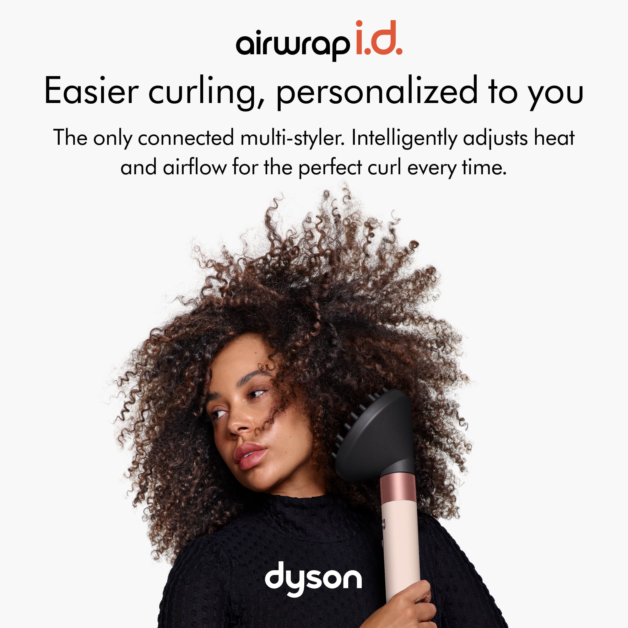 The image features a woman holding a hair curling tool, which is advertised as an "airwrap i.d." The tool is designed to make curling easier and more personalized to the user. It is the only connected multi-styler that intelligently adjusts heat and airflow for the perfect curl every time. The brand behind this innovative hair tool is Dyson.