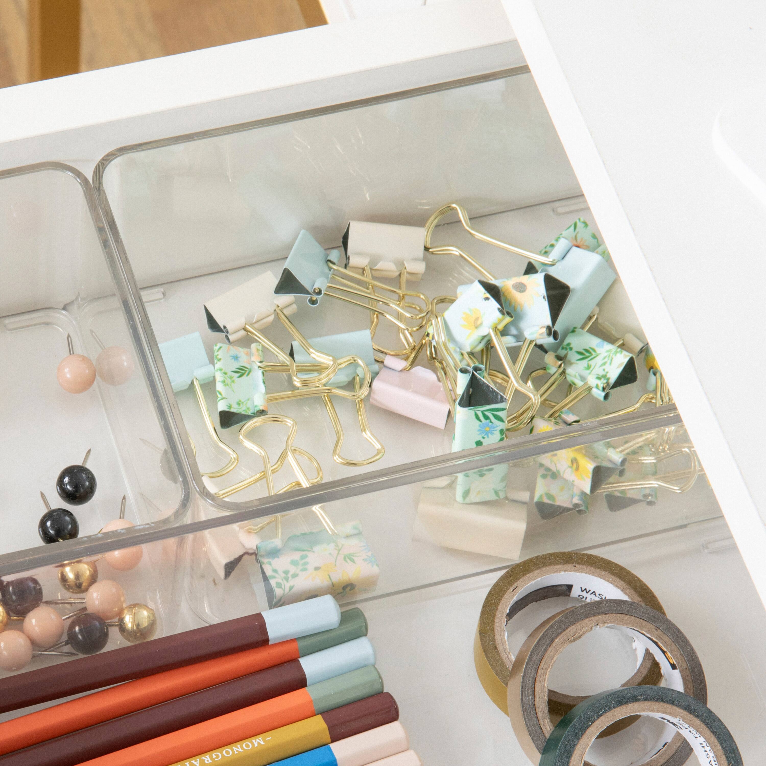 The image shows a variety of items, including a drawer full of office supplies such as pencils, scissors, and tape. There are also several pairs of scissors and pencils scattered around the drawer. Additionally, there are some pencils in a cup, and a pair of scissors is placed in a container. The items are organized in a way that makes it easy to find and access them when needed.