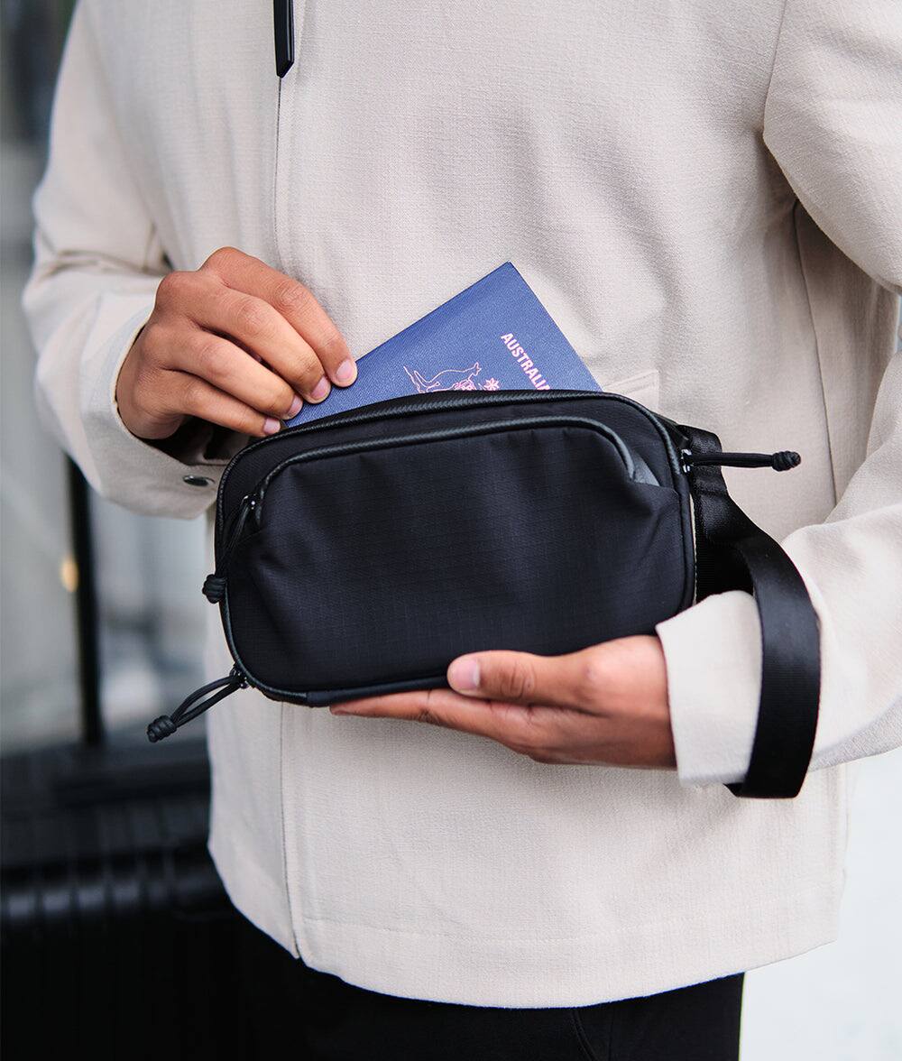 Alt View 8. ALPAKA - Bravo Passport Pouch Sling Bag for Men, Passport Holder for Travel, Fits iPhone Pro Max, RFID, AirTag Sleeve - Black Axoflux 210D.