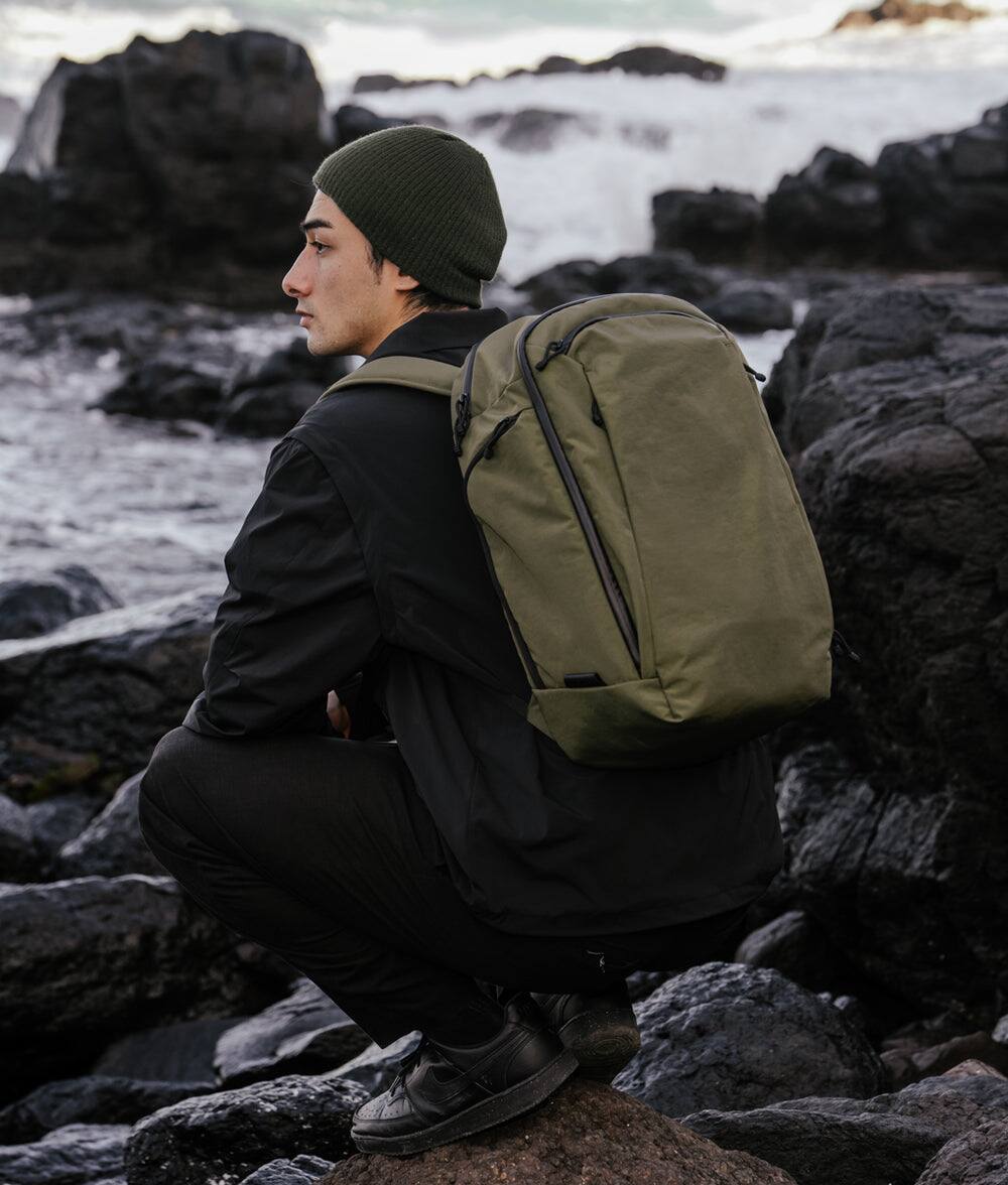 Angle. ALPAKA - Traverse 30L Travel Laptop Backpack for 16-Inch Laptops, Clamshell Opening, Luggage Pass-Through and Bottle Pocket - Green Axoflux 400D Ripstop Nylon.