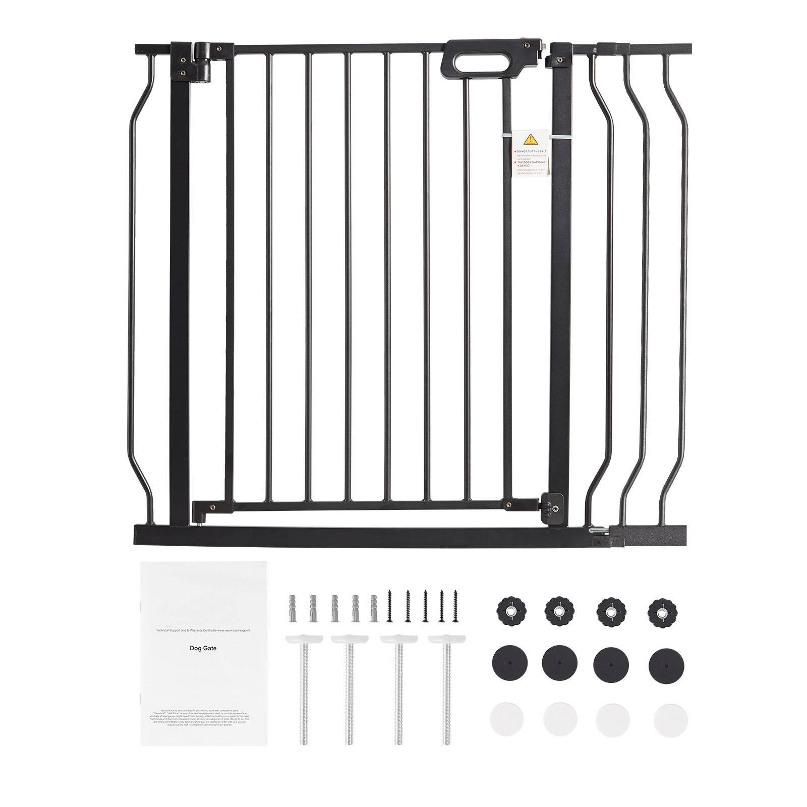 The image shows a black metal dog gate with vertical bars and a handle at the top. Below the gate, there are screws, bolts, and other hardware components laid out, along with a manual labeled "Dog Gate."