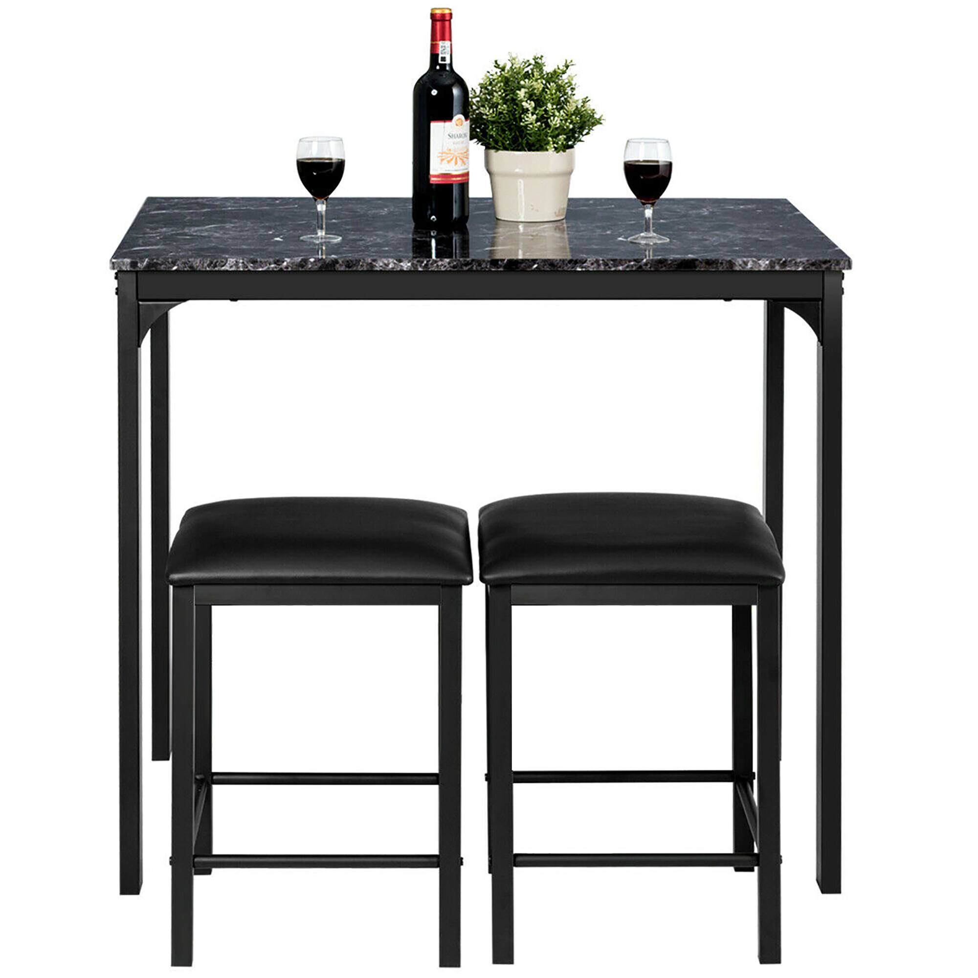 The image shows a table with two black stools, a bottle of wine, and two wine glasses. The table is set for a cozy wine tasting or a relaxing evening with a glass of wine. The wine glasses are placed on the table, one closer to the left stool and the other closer to the right stool. The bottle of wine is positioned between the two glasses, and a potted plant is also present on the table, adding a touch of greenery to the scene.