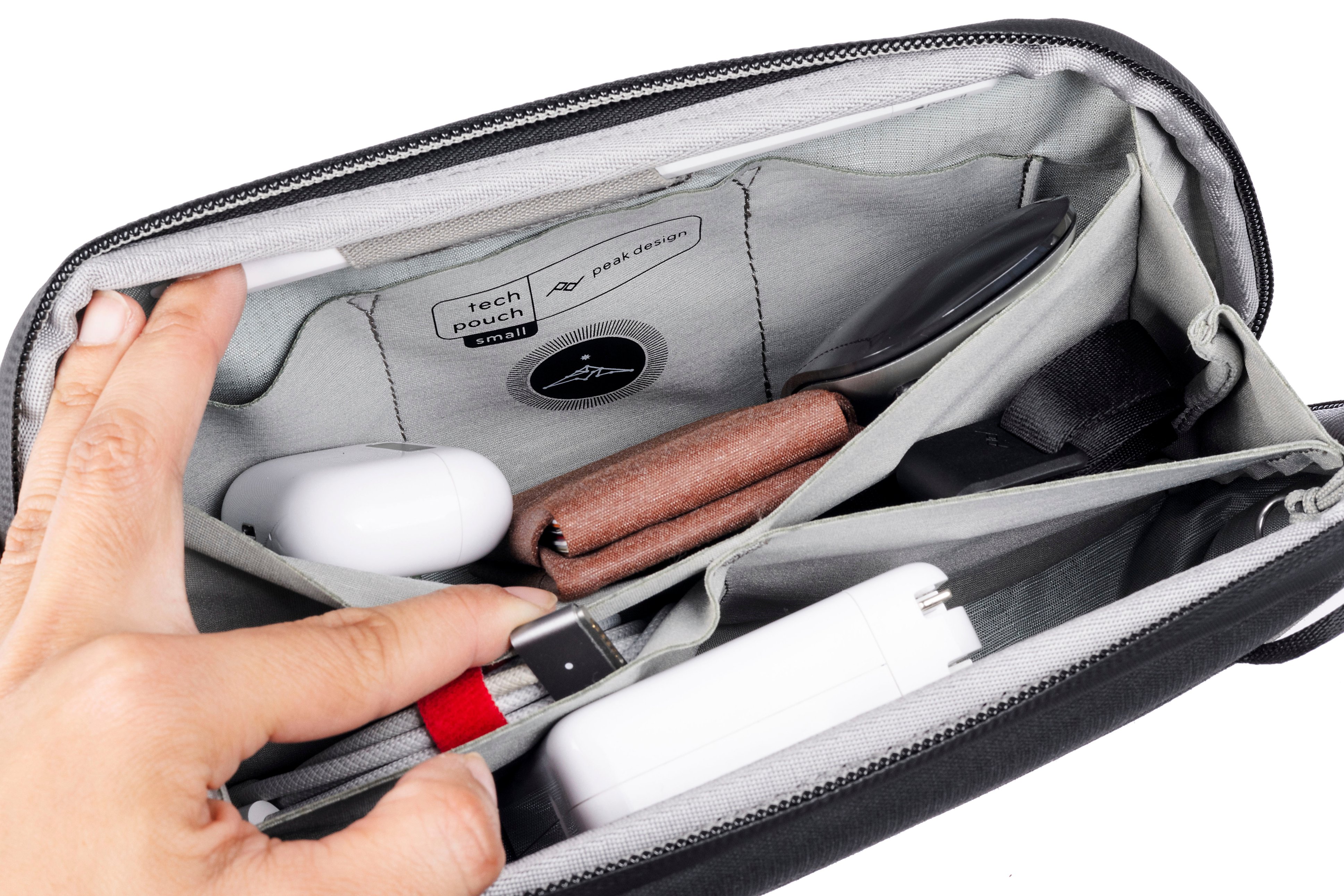 The text on the image is "Tech pouch small peakdesign design peak".