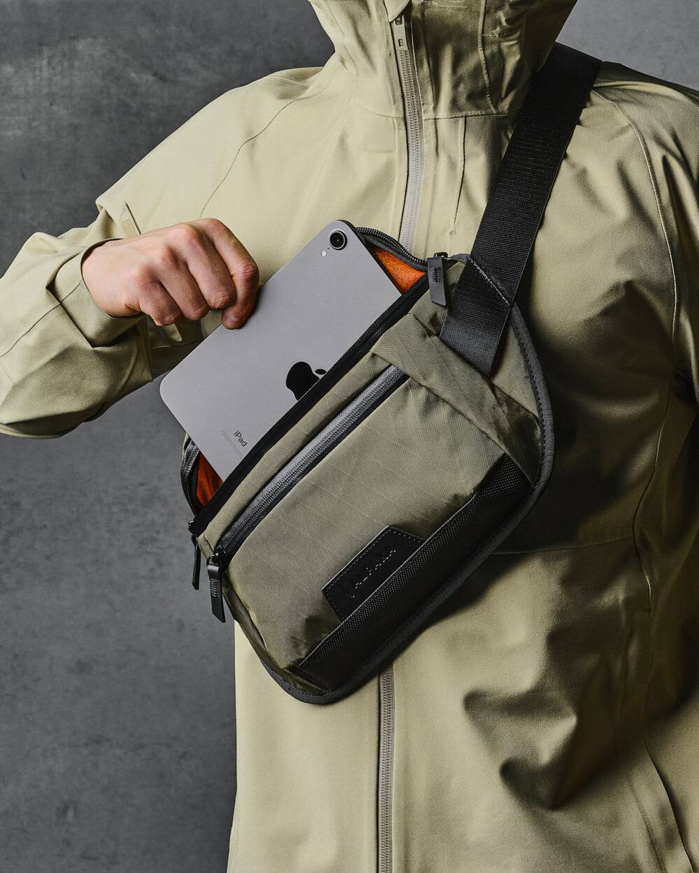 Left. ALPAKA - Sling Bag Bag for Men, Fits iPad Mini & Switch OLED, Hidden Rear Pocket, Magnetic Buckle, YKK AquaGuard Zippers - Olive Green X-Pac X42.