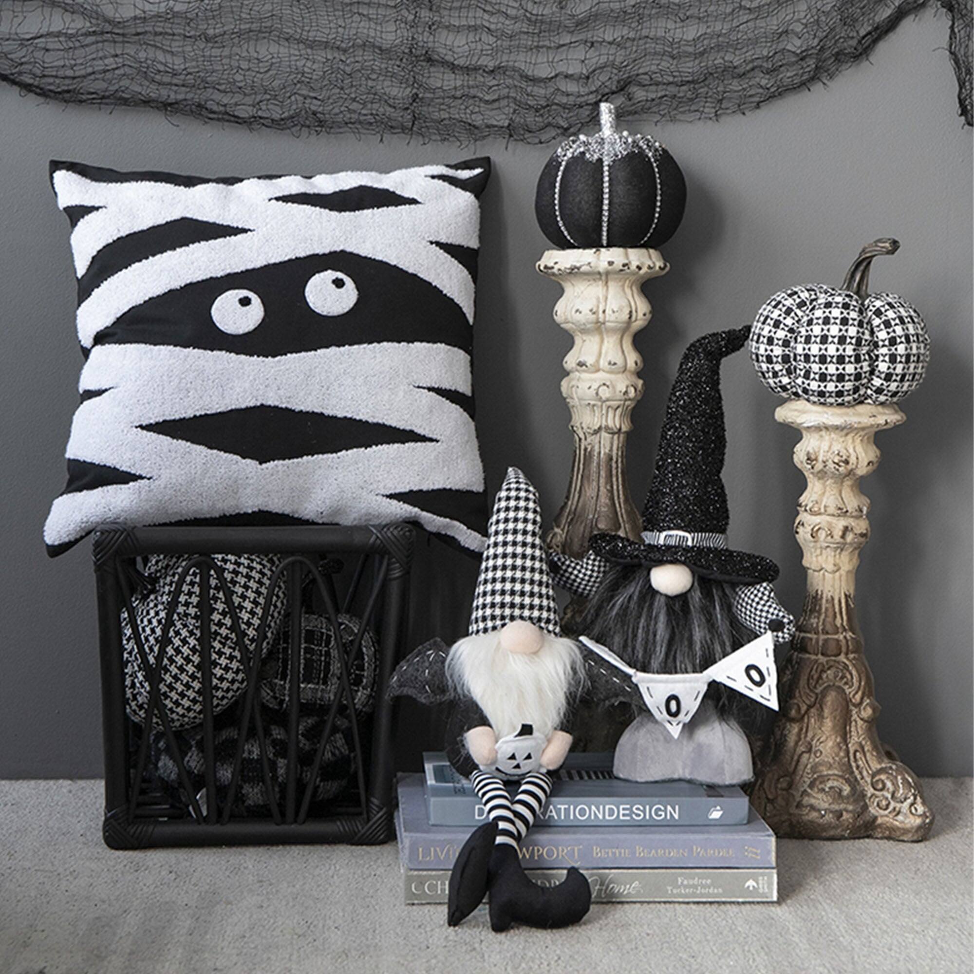 Certainly! Here is the corrected and grouped text from the image:

---

**Books:**
- LIV
- CCH
- DESIGN
- PORT BETTIL BEARDEN PARDEE
- Faudree
- Home
- Tucker-James

**Text on Decor:**
- O D A T I O N D E S I G N

---

This text appears on the books and the decorative pillow in the image.