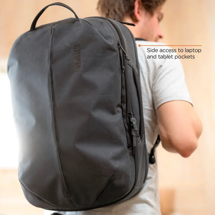 The text on the image reads "THULE Side access to laptop and tablet pockets."