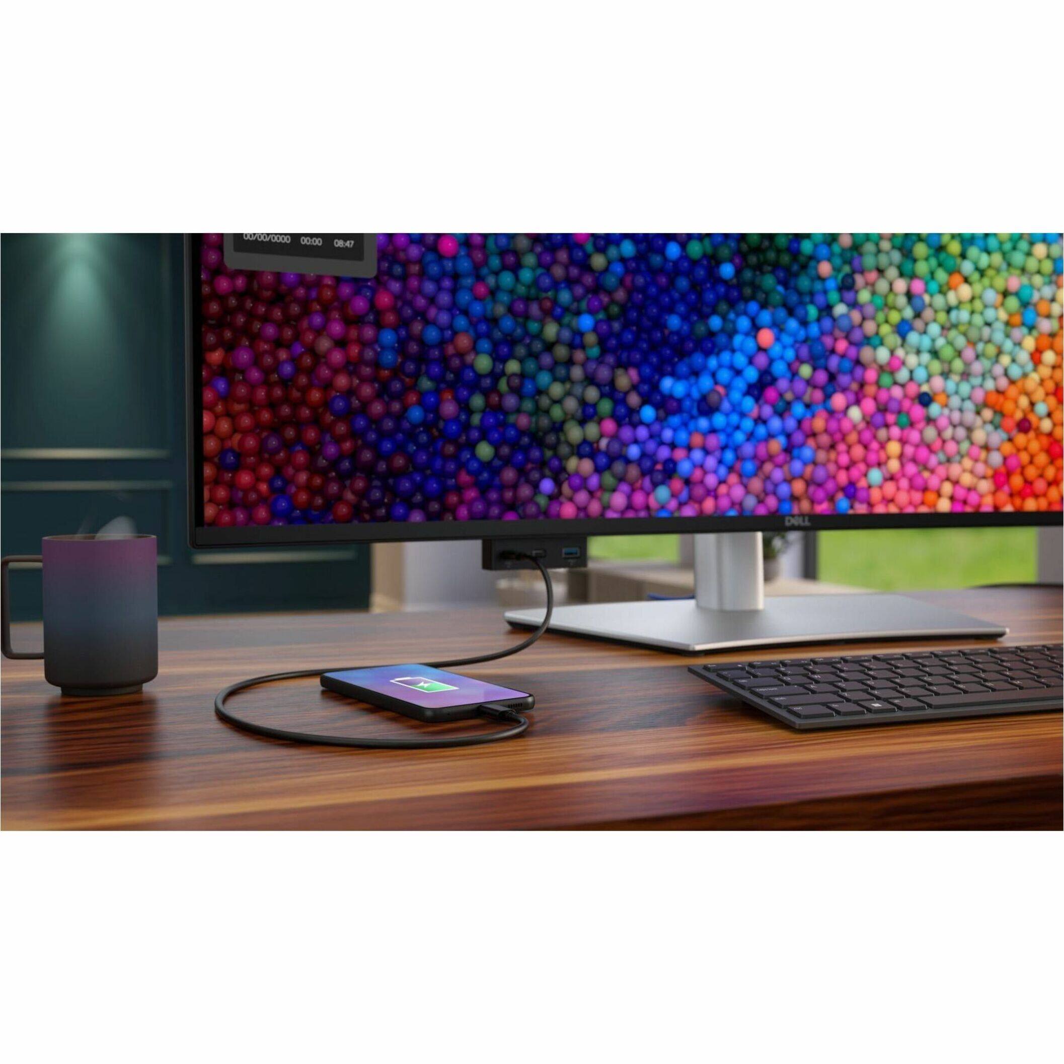 Dell computer monitor with a cell phone on top of it.