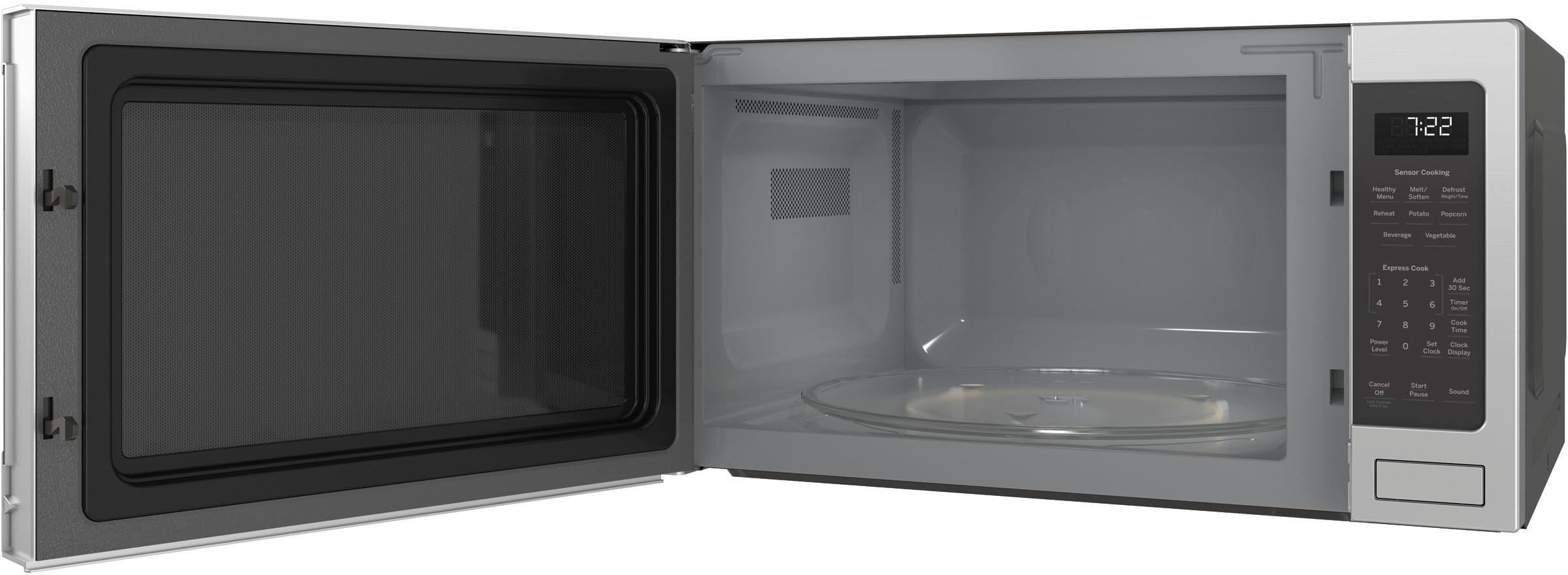 Left View: GE - 1.5 Cu. Ft. Mid-Size Microwave - Black on black