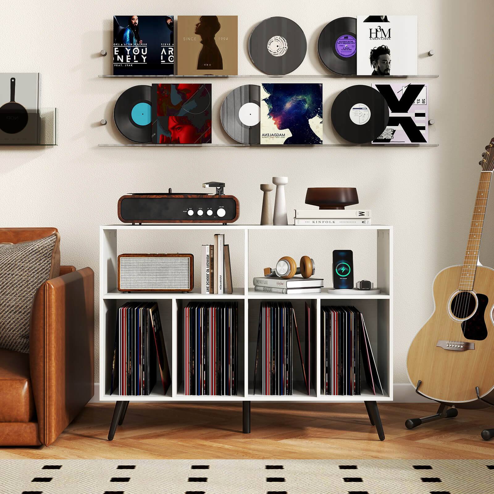 Sure, here is the corrected and grouped text from the image:

1. **Album Covers:**
   - "ONE ALBUM ONLY"
   - "E YOU NELY"
   - "AR LO"
   - "SINCE 1974"
   - "H&M"
   - "ROCK"
   - "AVIADRAM"

2. **Books and Items on the Shelf:**
   - "KINFOLK"
   - "LIFE IS A BOWL OF RICE"
   - "HOLY"

3. **Other Text:**
   - "SINFOLE"
   - "MAGOALENA"
   - "OX"