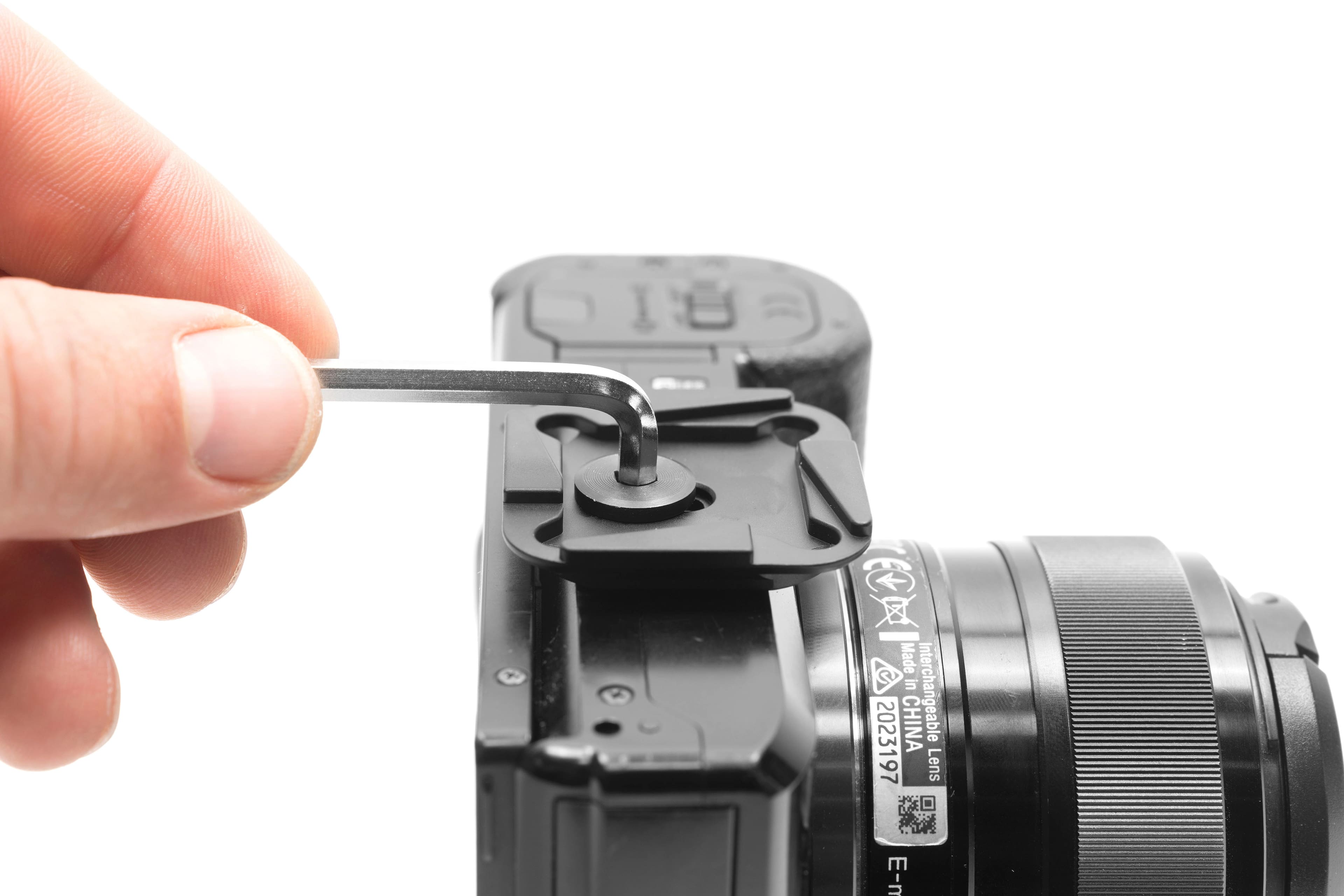 The text on the image reads "Made in CHINA Interchangeable Lens E-m 2023197."