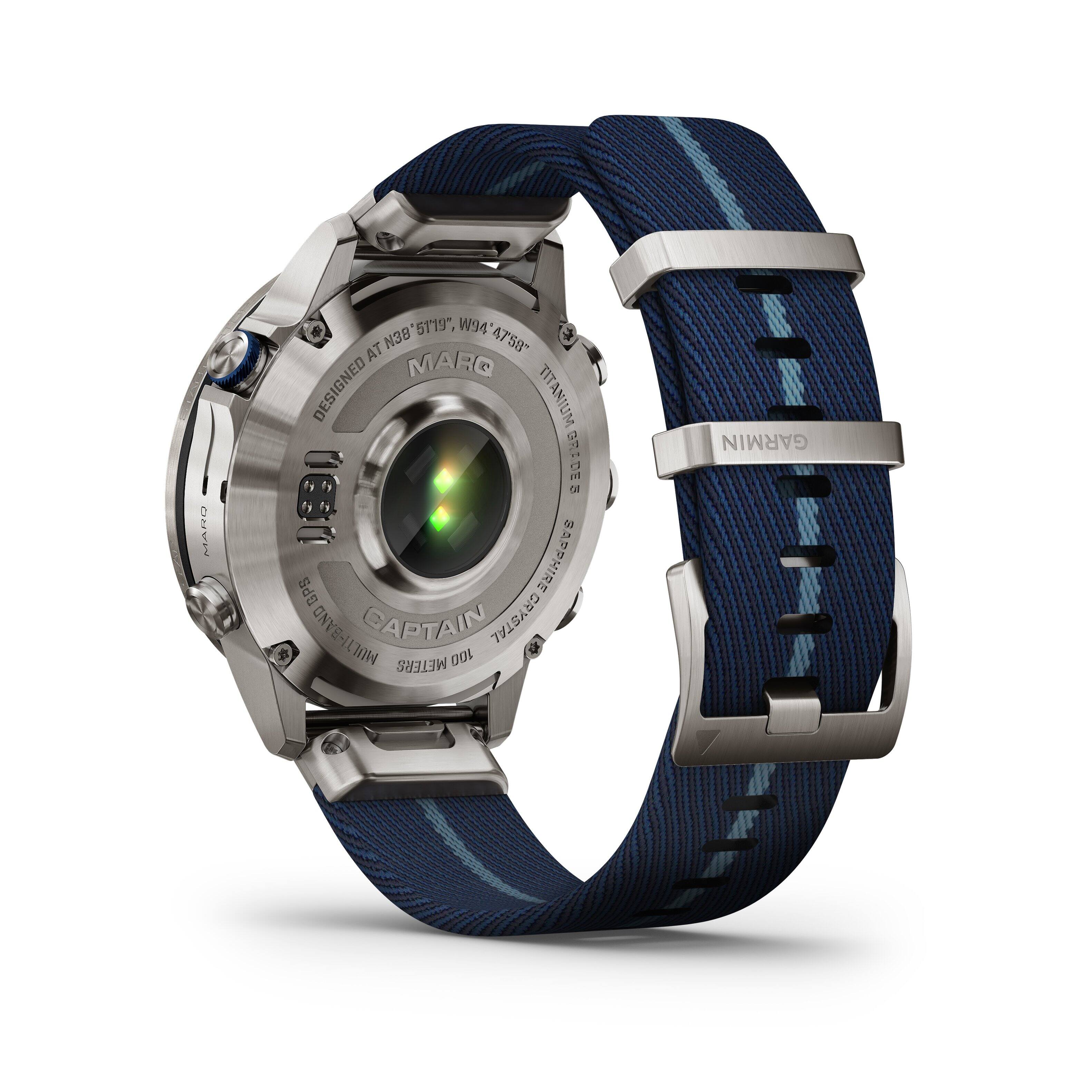 The image features a watch with a blue band and the words "Captain Grystal" written on it. The watch is designed by Marq and is made of titanium. It also has a GPS feature and is equipped with a sapphire crystal. The watch is displayed on a white background.