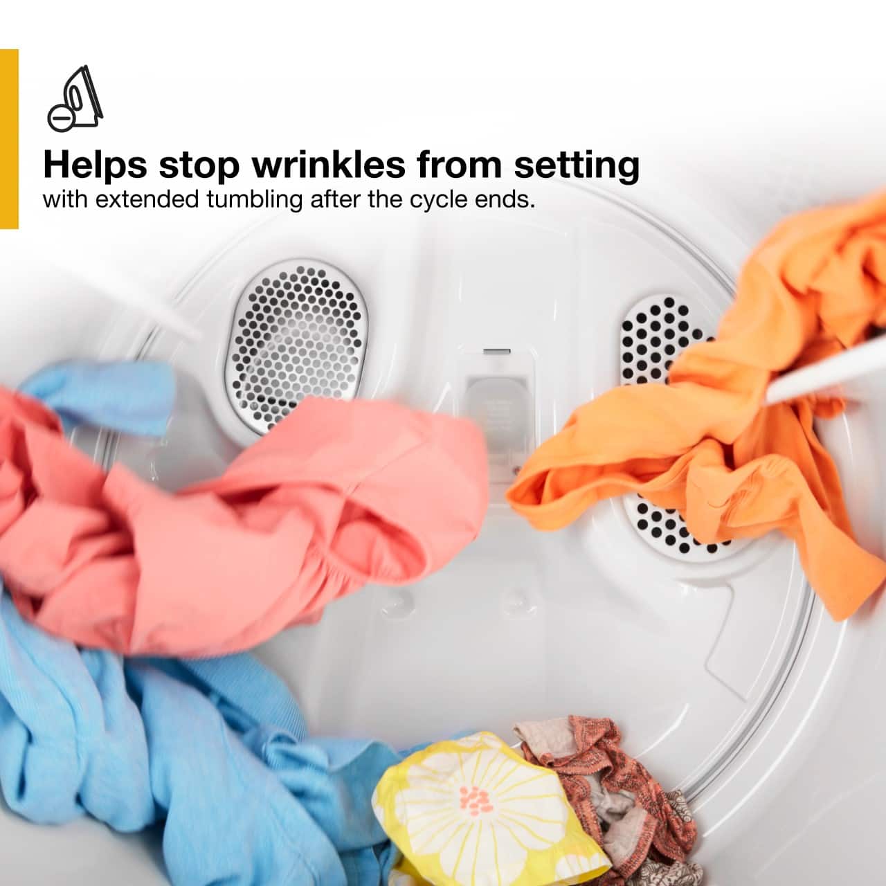 The image shows a washing machine filled with clothes, including a pile of folded towels and a pile of clothes. The machine is designed to help stop wrinkles from setting with extended tumbling after the cycle ends. This feature ensures that the clothes and towels come out of the machine looking neat and wrinkle-free, making it easier for the user to iron or fold them.