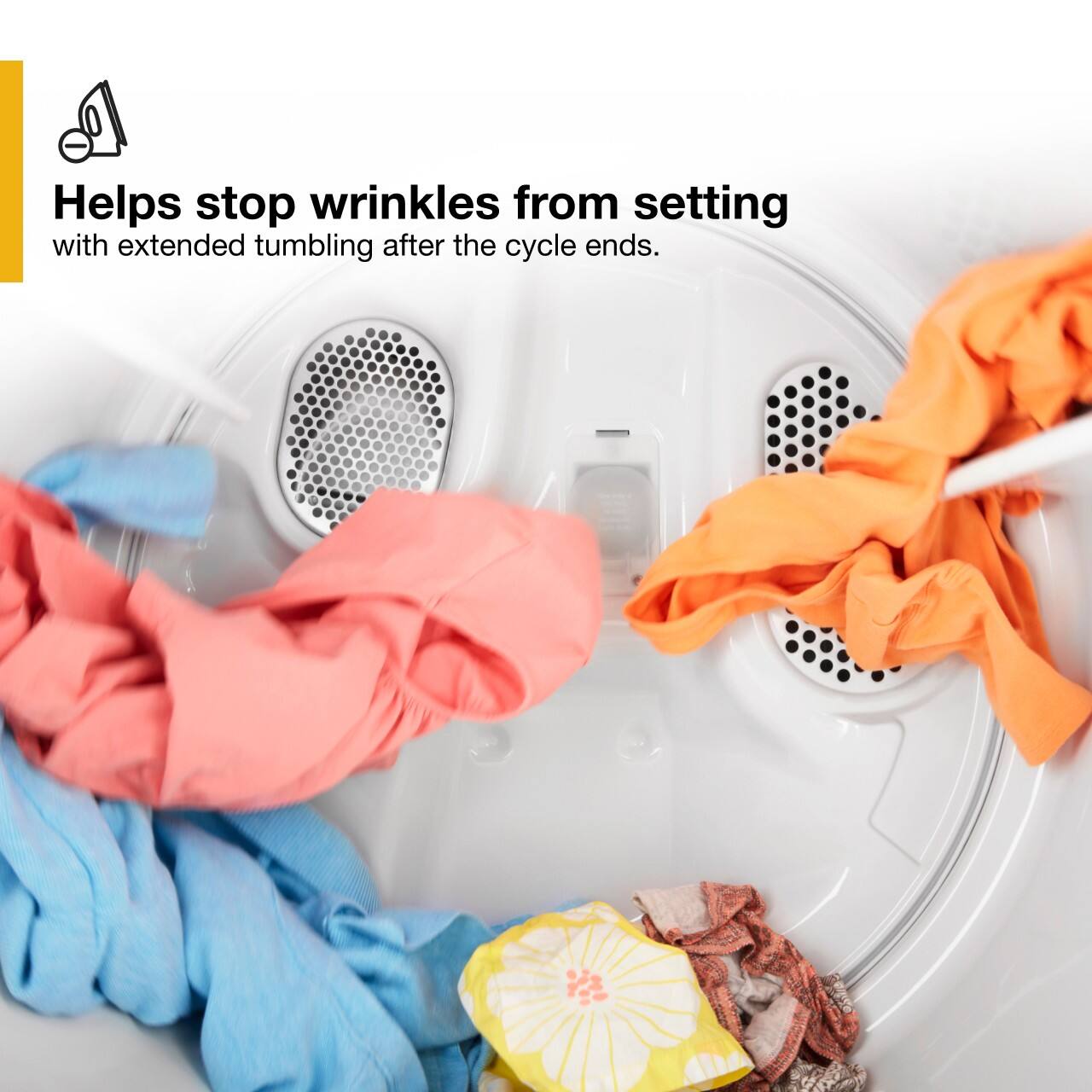 The image shows a washing machine filled with clothes, including a pile of folded towels and a pile of clothes. The machine is designed to help stop wrinkles from setting with extended tumbling after the cycle ends. This feature ensures that the clothes and towels come out of the machine looking neat and wrinkle-free, making it easier for the user to iron or fold them.