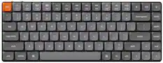 The image shows a close-up of a computer keyboard with a white background. The keyboard has a gray and black color scheme, and it features a variety of keys, including letters, numbers, and function keys. The keys are arranged in rows, with some keys located at the top, middle, and bottom of the keyboard. The keyboard also includes a space bar, which is a key used for typing spaces in text. Additionally, there is a key labeled "fn" on the keyboard, which is a function key that can be used in combination with other keys to perform specific actions.