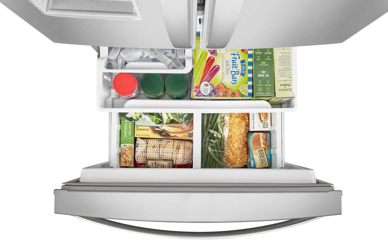 The image features a large refrigerator with its door open, revealing a variety of food items stored inside. The refrigerator is filled with different types of food, including a wide assortment of fruits and vegetables. There are at least 13 bottles of various sizes and shapes, some placed on the upper shelves and others on the lower shelves. The refrigerator is well-stocked and organized, making it an ideal choice for those who enjoy a diverse range of food options.