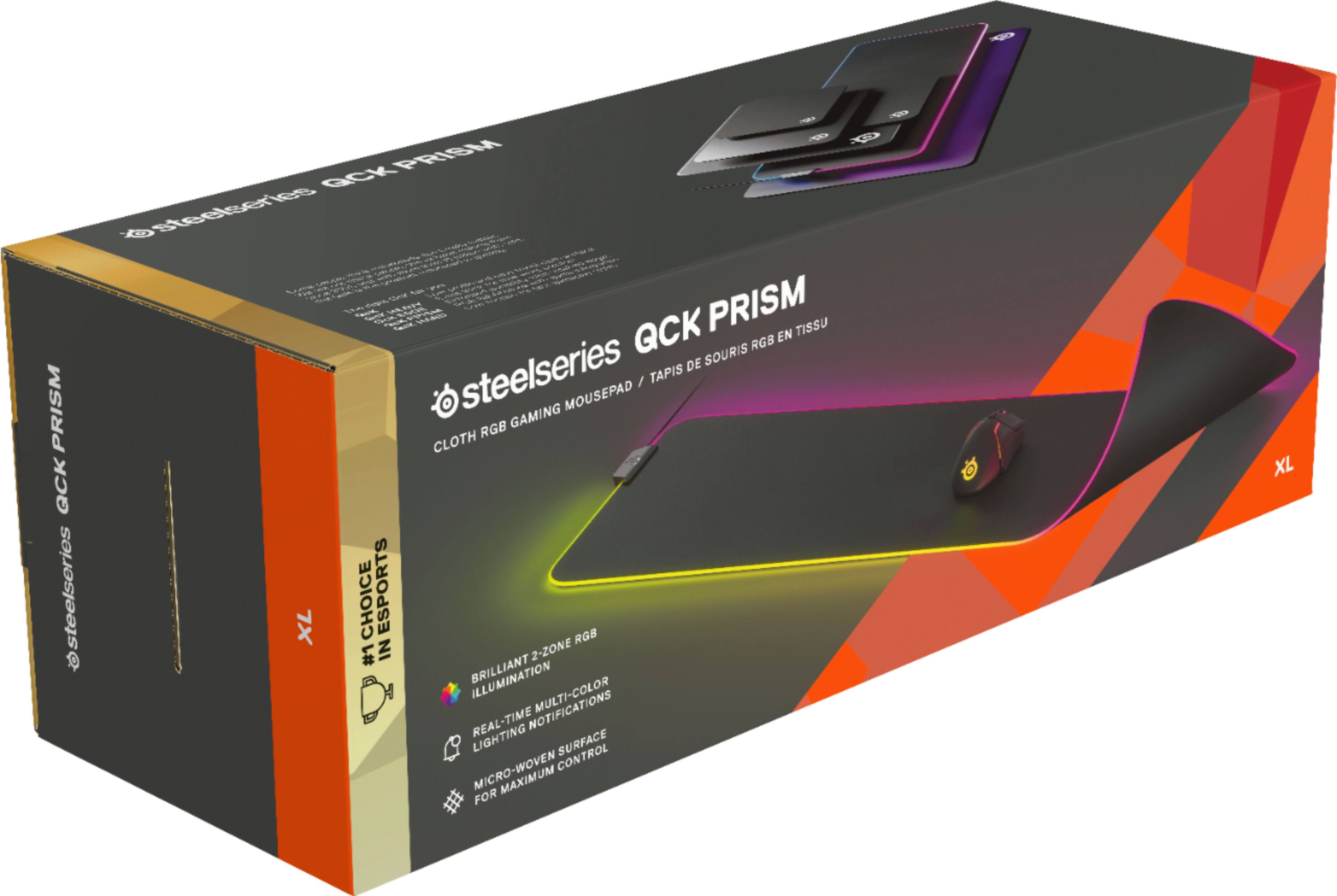 The text on the image reads: "PRISM QCK steelseries PRISM TISSU RGB EN DE SOURIS steelseries MOUSEPAD / TAPIS RGB GAMING CLOTH XL CHOICE ESPORTS RGB #1 IN 2-ZONE BRILLIANT REAL-TIME NOTIFICATIONS LIGHTING SURFACE MICRO-WOVEN CONTROL FOR XL."