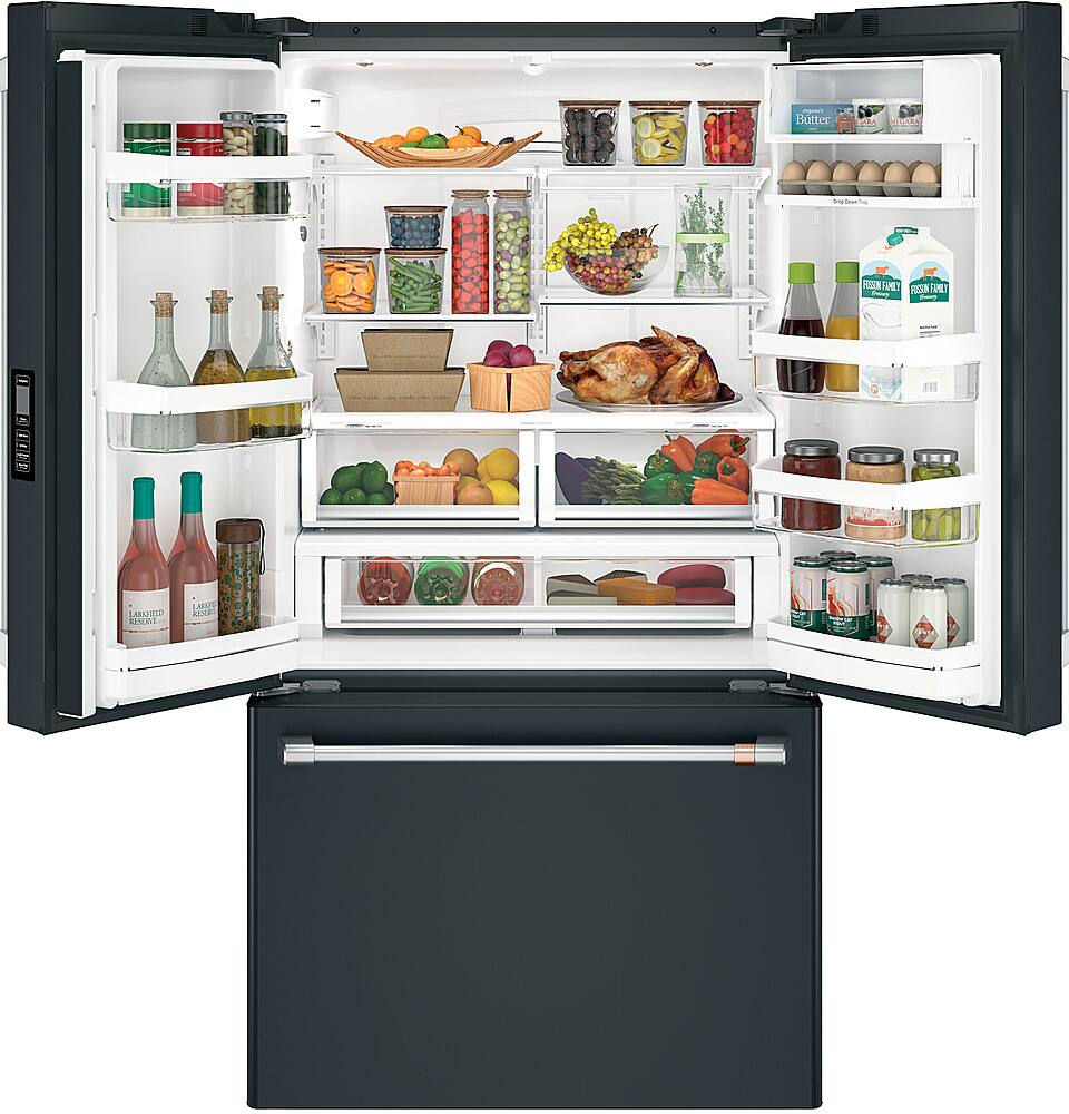 The image features a large refrigerator filled with various food items. The refrigerator has a door open, revealing a wide assortment of items inside. There are several bottles of different sizes and shapes, some of which are placed on the top shelves, while others are located on the middle and lower shelves. 

In addition to the bottles, there are multiple carrots placed throughout the refrigerator, with some located on the top shelves and others on the middle and lower shelves. The refrigerator also contains a bowl, which is placed on one of the middle shelves. The variety of food items in the refrigerator suggests that it is well-stocked and ready for use.