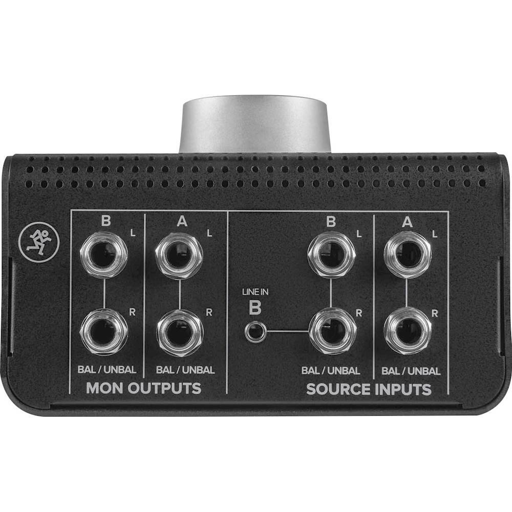 The image shows a black box with a row of 12 knobs, labeled as "BAL/UNBAL" and "MON OUTPUTS." The knobs are arranged in a linear fashion, with some knobs labeled "BAL" and others labeled "UNBAL." The box also has a "SOURCE INPUTS" label, indicating that it is a source input device. The arrangement of the knobs suggests that they are used to control various audio settings, such as volume or balance, for a sound system.