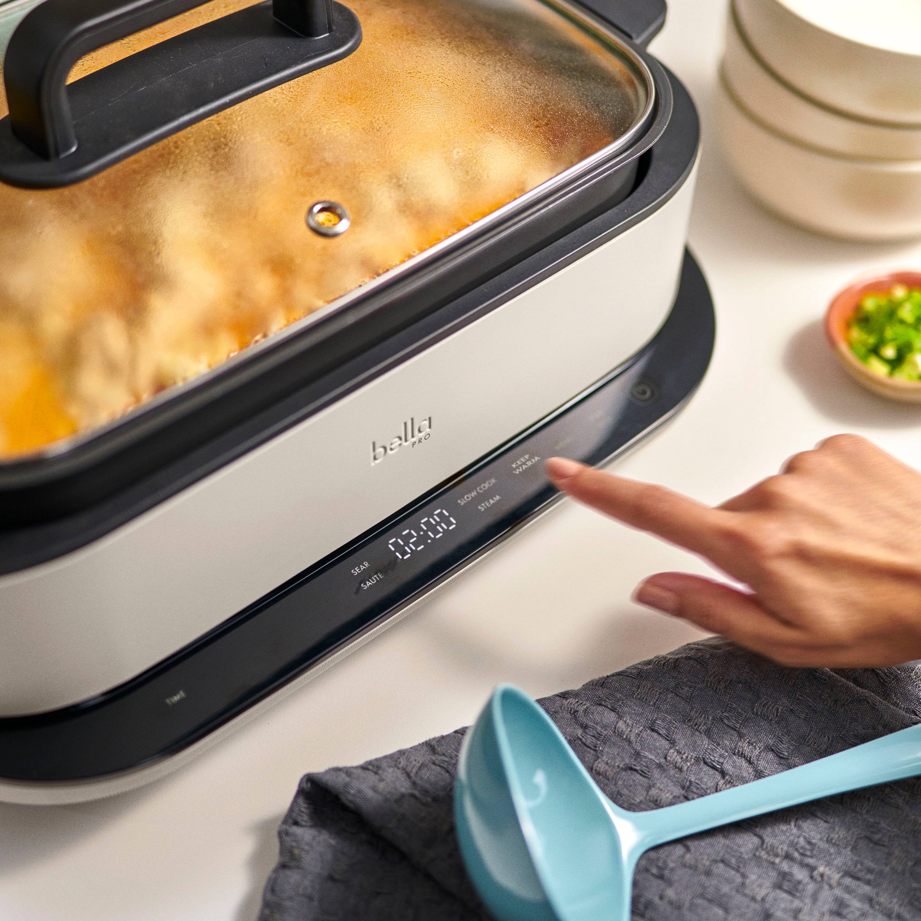 The text on the image reads "bella P2 SLOWCOOK Cdo SUDW STEAM 02:00 SEAR SAUTE."