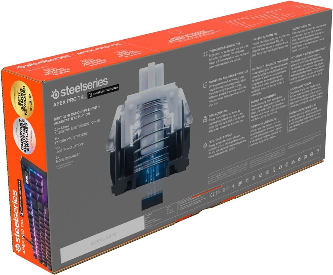 The image features a box for a steelseries TKL OMNIPOINT SWITCHES GAMING KEYBOARD. The box is white and orange, and it contains a TKL PRO Q. APEX FACTOR FORMA, which is a tenkeyless play form. The box also includes adjustable points, allowing for a customized gaming experience. The steelseries TKL PRO Q. APEX FACTOR FORMA is designed to provide a competitive edge with its fast and durable switches. The box is open, revealing the keyboard inside.