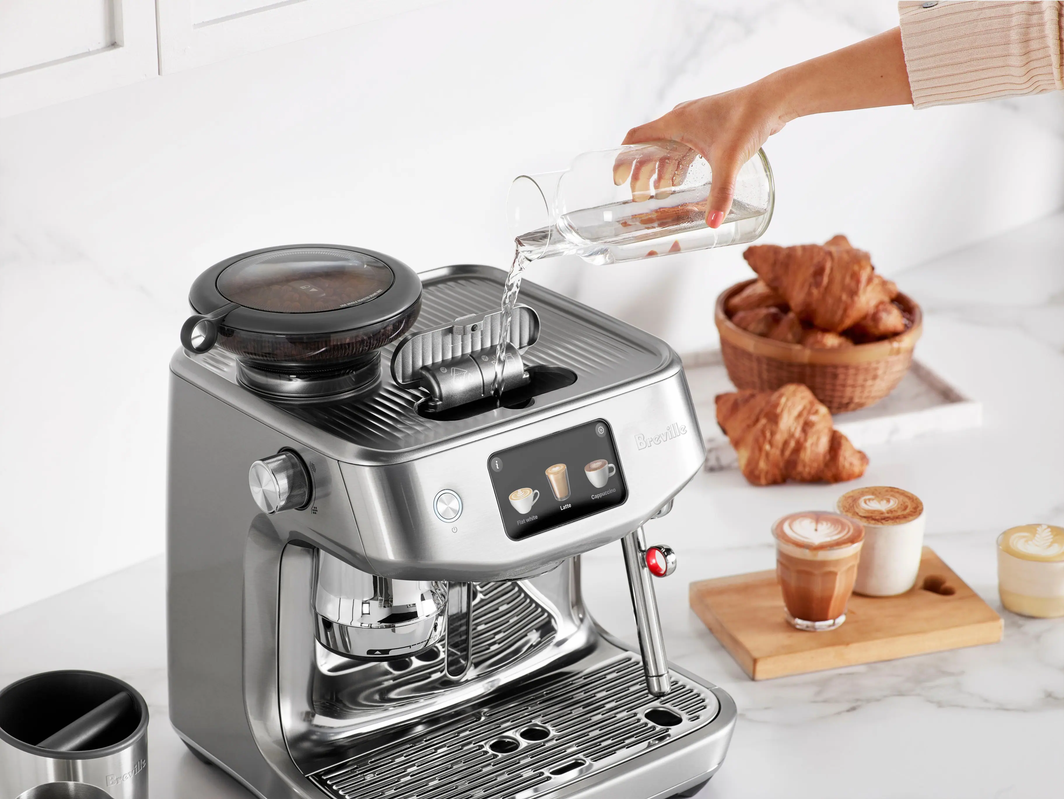 Breville espresso machine with a bowl of croissants.