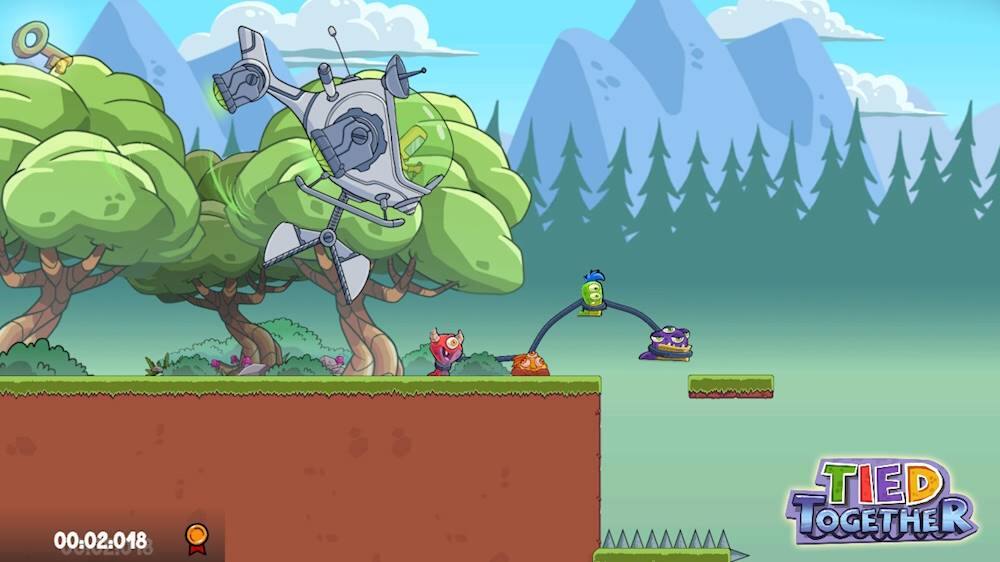 The image features a video game with a robot and a character on a platform. The robot is holding a rope, and the character is hanging from it. The scene takes place in a forest setting with trees in the background. The game appears to be a platformer, and the characters are interacting with each other, possibly as part of a puzzle or challenge. The image also includes a timer, indicating that the game may have a time limit or be part of a race.