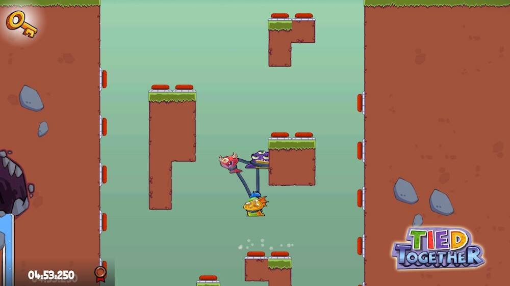 The image shows a video game character, possibly a robot, navigating through a maze-like environment. The character is moving through a series of obstacles, such as rocks and water, while trying to reach the end of the maze. The game appears to be a platformer or a puzzle game, with the character possibly being a part of a game called "Tied Together." The game is set in a dirt-like environment, and the character is using a crane to help them progress through the obstacles.